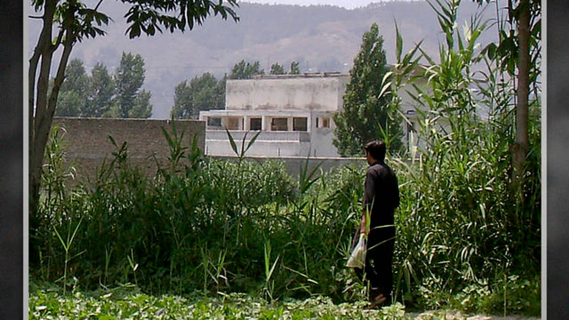 FILE: A local residents walks near a house where Al Qaeda leader Usama bin Laden was killed, Abbottabad, Pakistan.
