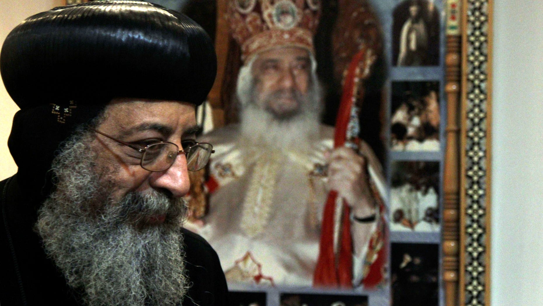 FILE - In this Sunday, Nov. 4, 2012 file photo, Bishop Tawadros, 60, soon to be Pope Tawadros II greets well-wishers, not shown, after being named the 118th Coptic Pope in the Wadi Natrun Monastery complex northwest of Cairo, Egypt. Egypt's Coptic Christian pope has sharply criticized the country's Islamist leadership in an interview with The Associated Press, Tuesday, Feb. 5, 2013, saying the new constitution is discriminatory and that Christians should not be treated as a minority. Pope Tawadros II also dismisses calls by President Mohammed Morsi for a national dialogue, saying, “We will actively take part in any national dialogue that would benefit the nation, but when a dialogue ends before it starts and none of its results are implemented then we do not take part.” (AP Photo/Roger Anis, El Shorouk Newspaper, File) EGYPT OUT
