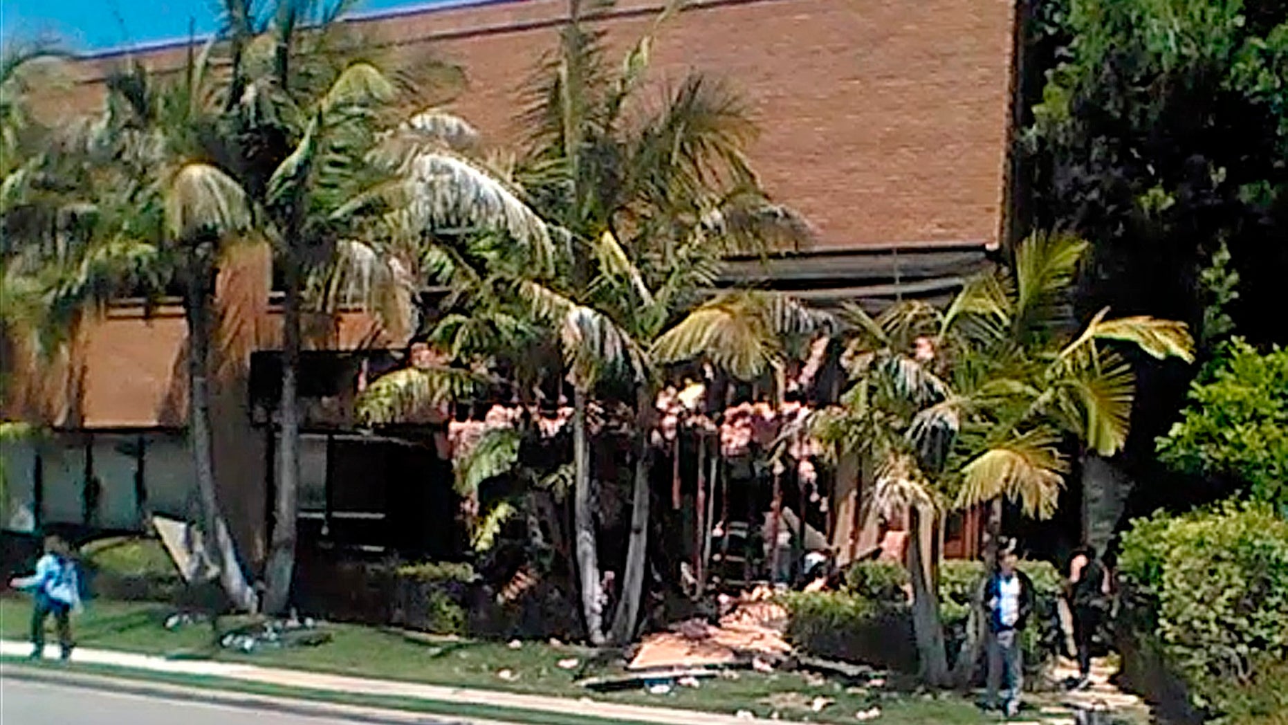 This image taken from cellphone video shows a building after a fatal explosion in Aliso Viejo, Calif., Tuesday, May 15, 2018. The cause of the blast is being investigated.