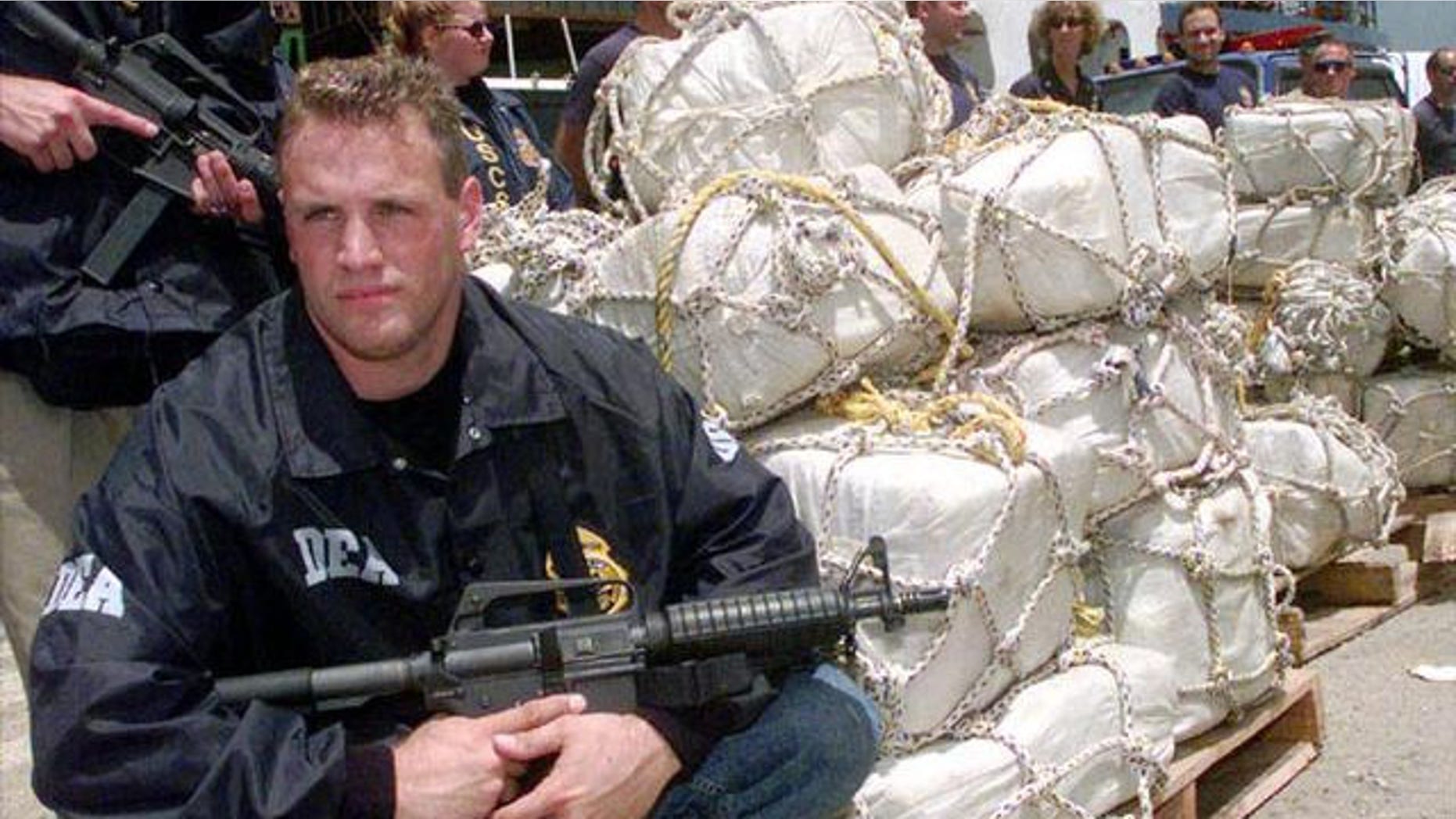 A DEA agent guards a pile of confiscated cocaine (AP Photo)