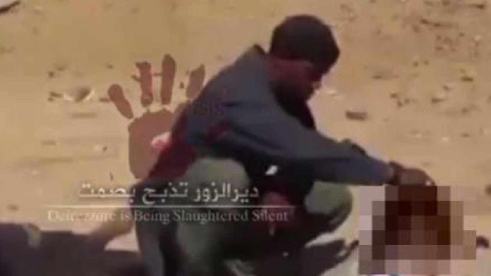 In this screengrab from a video believed to have been shot in November, Cuspert holds the severed head of a victim of ISIS (Raqqa is Being Slaughtered Silently)