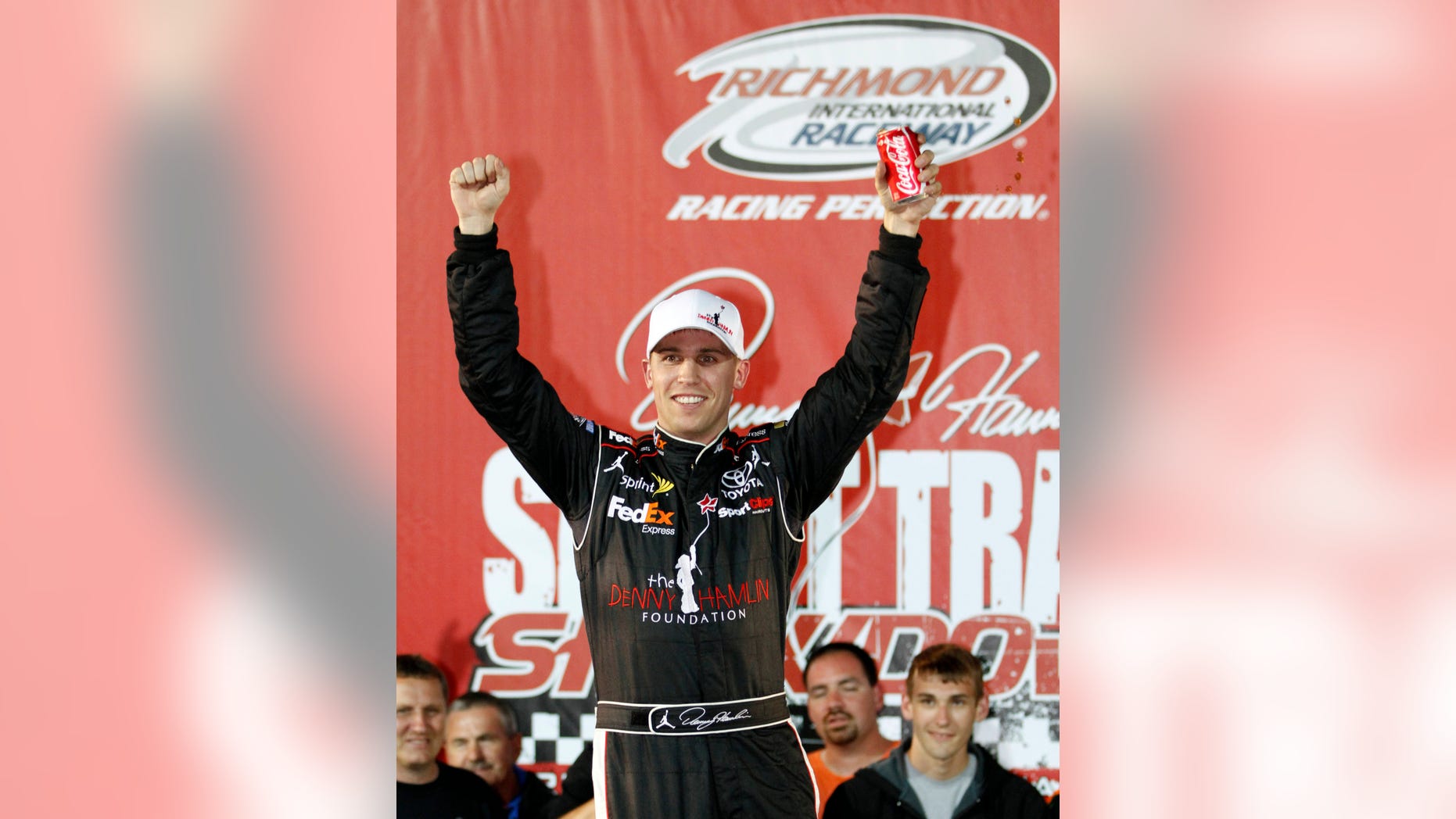 FILE - In this April 28, 2011 file photo, Denny Hamlin celebrates after winning the Denny Hamlin Foundation Short Track Showdown auto race at Richmond International Raceway in Richmond, Va. Hamlin won't compete in his annual charity race at home track Richmond because of the back injury that has sidelined him for at least a month. (AP Photo/Steve Helber, File)