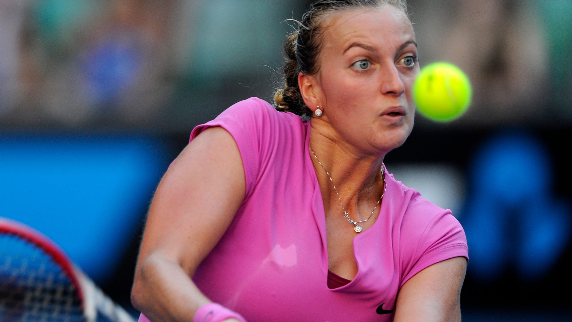 Petra Kvitova of the Czech Republic returns to Luksika Kumkhum of Thailand during their first round match at the Australian Open tennis championship in Melbourne, Australia, Monday, Jan. 13, 2014. (AP Photo/Andrew Brownbill)