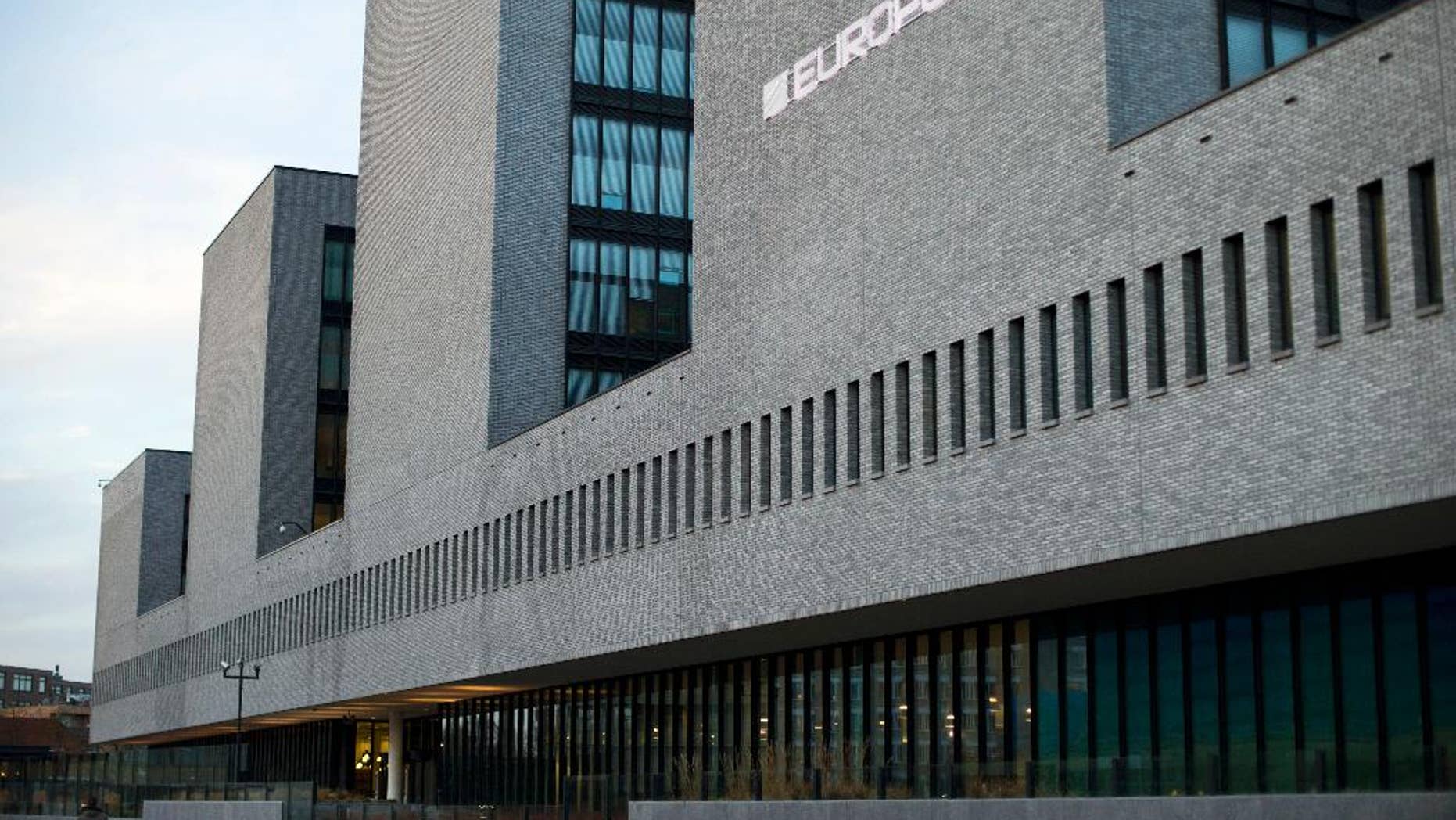 FILE - In this Jan. 16, 2015 file photo a man walks past the European police agency Europol in The Hague, Netherlands. European Union officials are seeking sweeping changes in bloc policies and practices to face new security risks arising from terrorism, organized crime and cybercrime. EU Commission vice president Frans Timmermans said Tuesday April 28, 2015 there is still too much “mistrust and reticence to cooperate” among European countries. (AP Photo/Peter Dejong, File)