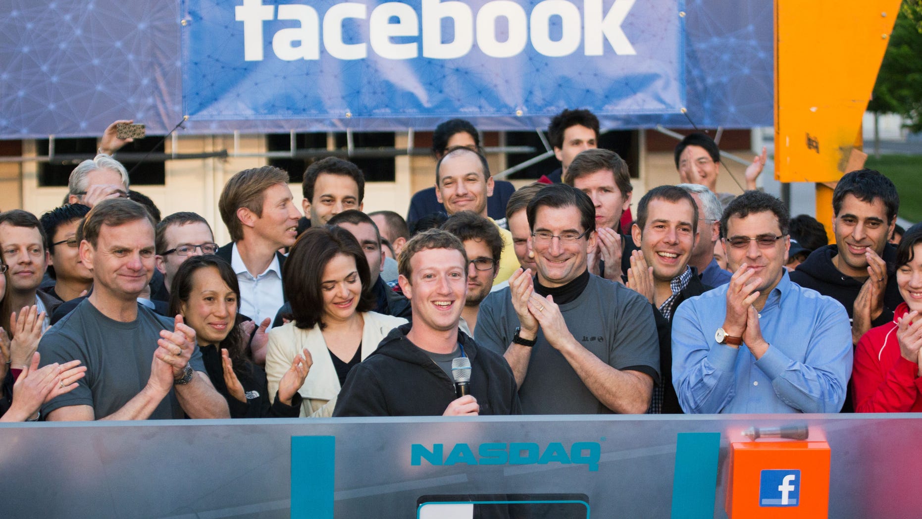Chairman and CEO Mark Zuckerberg, center, rings the opening bell of the Nasdaq stock market.