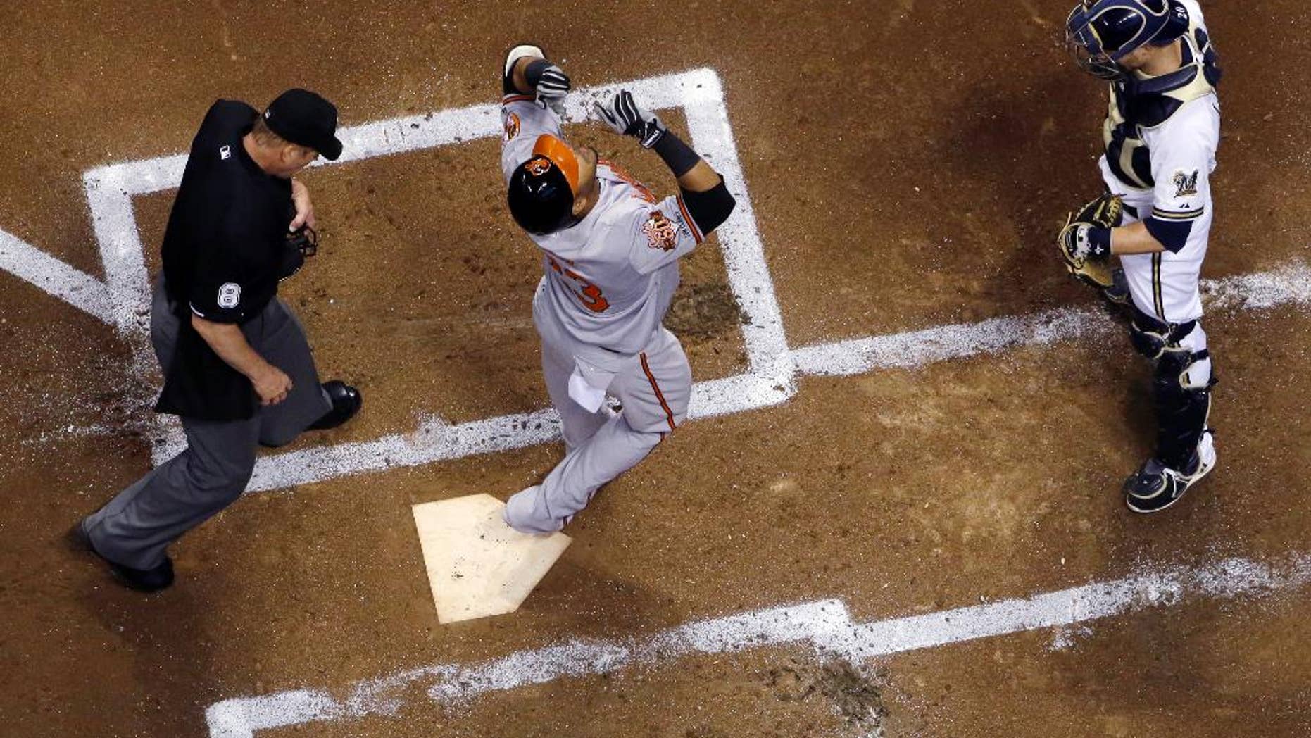 Baltimore Orioles' Nelson Cruz looks up as he crosses home after hitting a home run during the second inning of a baseball game against the Milwaukee Brewers on Wednesday, May 28, 2014, in Milwaukee. (AP Photo/Morry Gash)