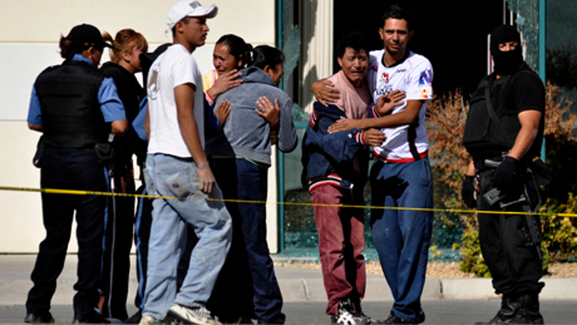 Relatives of fallen police officers react as they arrive to the scene after gunmen attacked a municipal police car in the northern border city of Ciudad Juarez, Mexico, Sunday Nov. 7, 2010. A male and a female officer were killed in the attack. Juarez has become one of the deadliest cities in the world as rival drug gangs battle for control of smuggling routes. (AP Photo/Raymundo Ruiz)