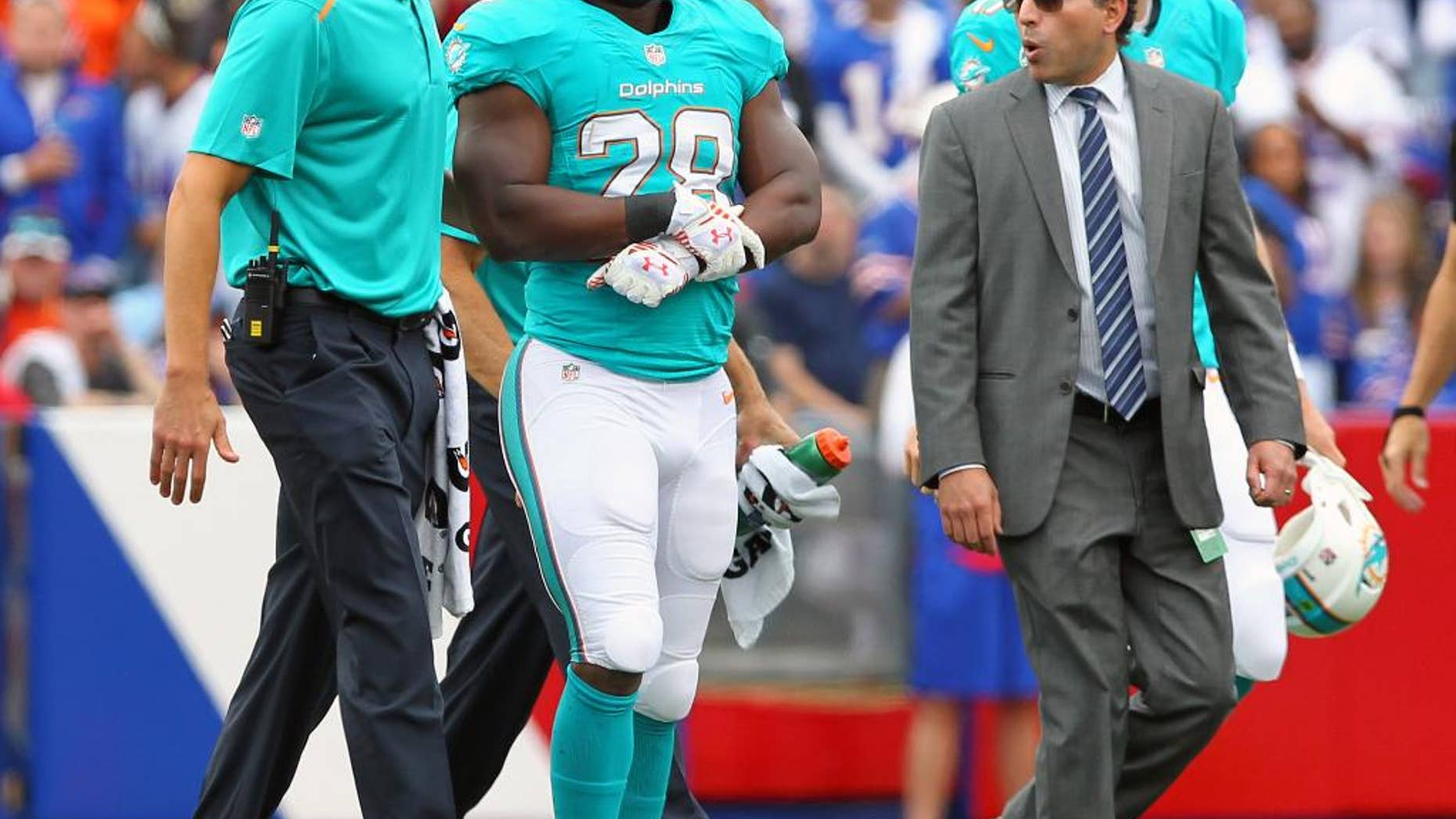 ADVANCE FOR WEEKEND EDITIONS OCT 4-5 - FILE - In this Sunday, Sept. 14, 2014 file photo, Miami Dolphins running back Knowshon Moreno (28) walks off the field after an injury during the first half of an NFL football game against the Buffalo Bills in Orchard Park, N.Y. The NFL's injury epidemic began even before any preseason games were played. Since then, big-name players (RG3, Knowshon Moreno, Sam Bradford, B.J. Raji, DeAngelo Hall, Chris Long) have been sidelined, Thursday, Oct. 2, 2014. (AP Photo/Bill Wippert, File)