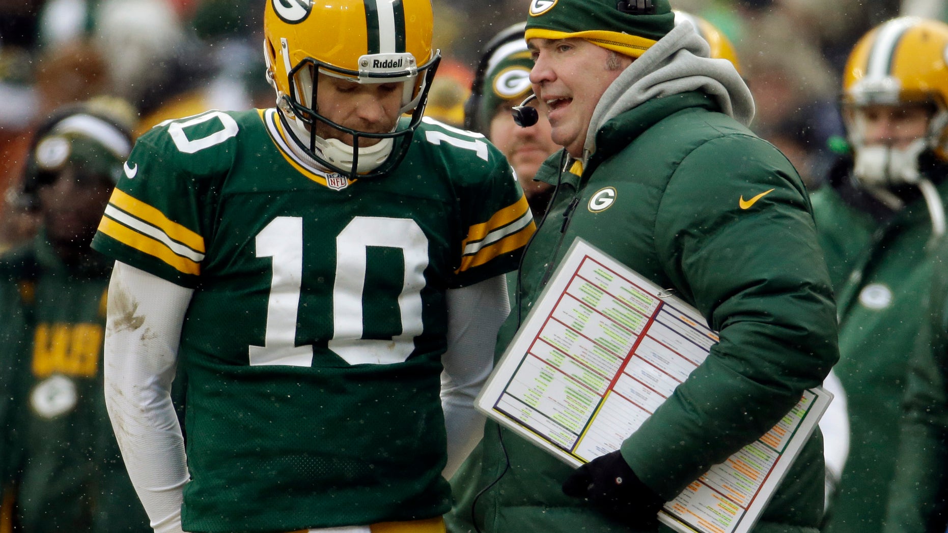Green Bay Packers head coach Mike McCarthy talks to Matt Flynn (10) during the first half of an NFL football game against the Atlanta Falcons Sunday, Dec. 8, 2013, in Green Bay, Wis. (AP Photo/Mike Roemer)