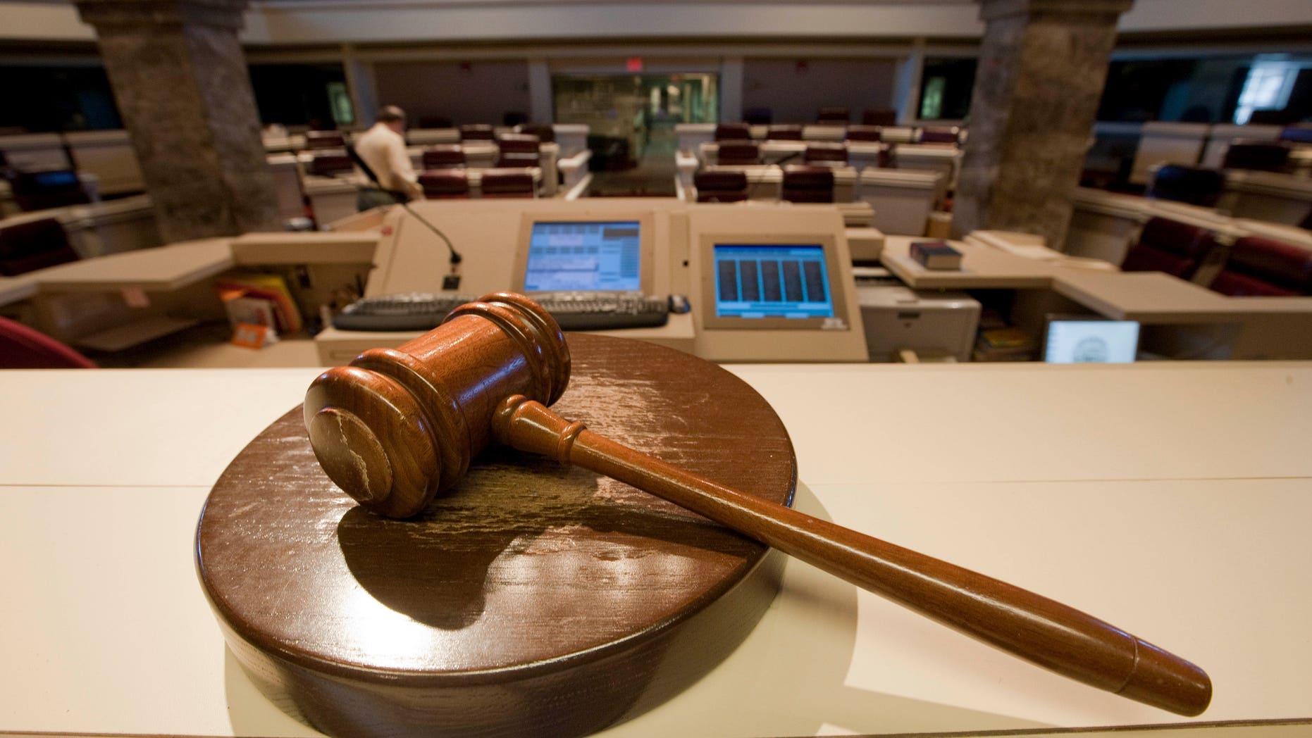The gavel stands ready as Alabama House Public Information Officer Clay Redden, rear, makes preparations House chamber in Montgomery, Ala., on Friday, Dec. 3, 2010 a for the special session on ethics legislation called by Gov. Bob Riley. The lawmakers come into session next Wednesday. (AP Photo/Dave Martin)