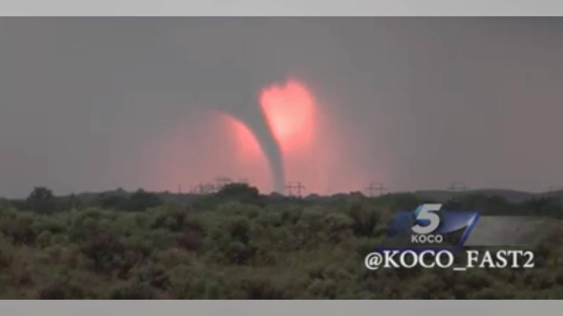 In this Monday, May 23, 2016 frame from video, a tornado moves through the area near Woodward, Okla., as the sun sets. More storms are in the forecast all week, with Kansas, Nebraska, Oklahoma and northeastern Colorado in the crosshairs on Tuesday. (KOCO via AP) MANDATORY CREDIT