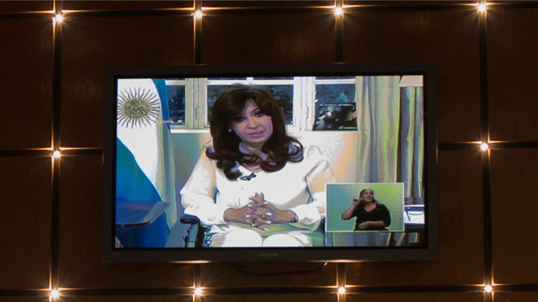 A television screen in a restaurant shows a nationally televised address by Argentina's President Cristina Fernandez, her first public comments since the death of prosecutor Alberto Nisman, in Buenos Aires, Argentina, Monday, Jan. 26, 2015. Fernandez called on Congress to dissolve Argentina's intelligence services in the wake of the mysterious death of Nisman, strongly denying his accusations that she had sought to shield former Iranian officials suspected in the 1994 bombing of a Jewish center. (AP Photo/Ivan Fernandez)