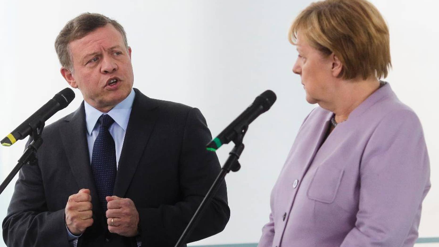 German Chancellor Angela Merkel, right, and King Abdullah II, of Jordan, brief the media prior to talks at the chancellery in Berlin, Friday, Oct. 7, 2016. (AP Photo/Markus Schreiber)