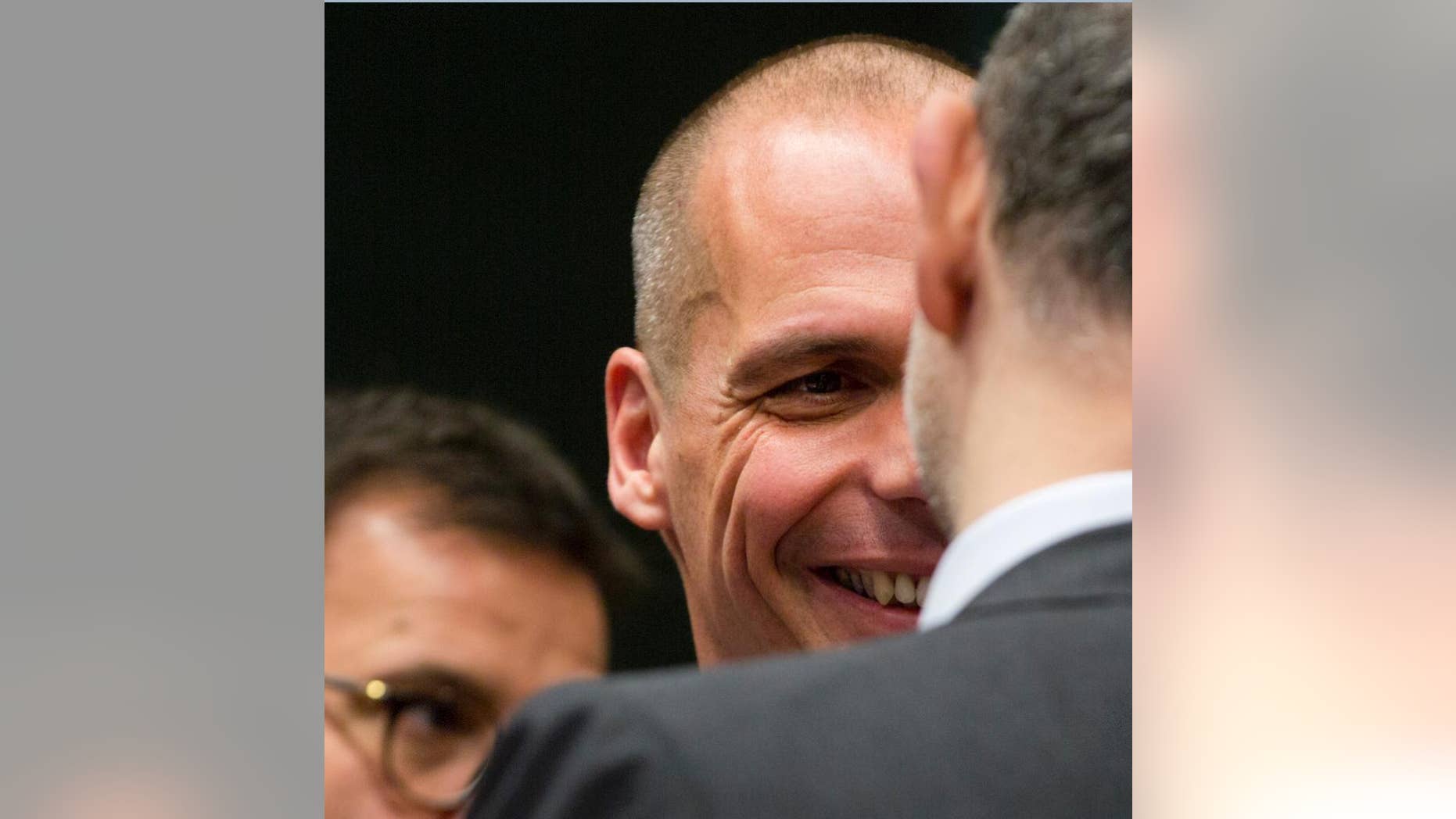 Greek Finance Minister Yanis Varoufakis, center, speaks with European Commissioner for the Economy Pierre Moscovici, right, during a meeting of the eurogroup finance ministers at the EU Council building in Brussels on Monday, May 11, 2015. Hopes for a deal between Greece and its European creditors at a key meeting Monday are slim, weighing on the region's stock markets as the country struggles to make upcoming debt repayments. (AP Photo/Virginia Mayo)