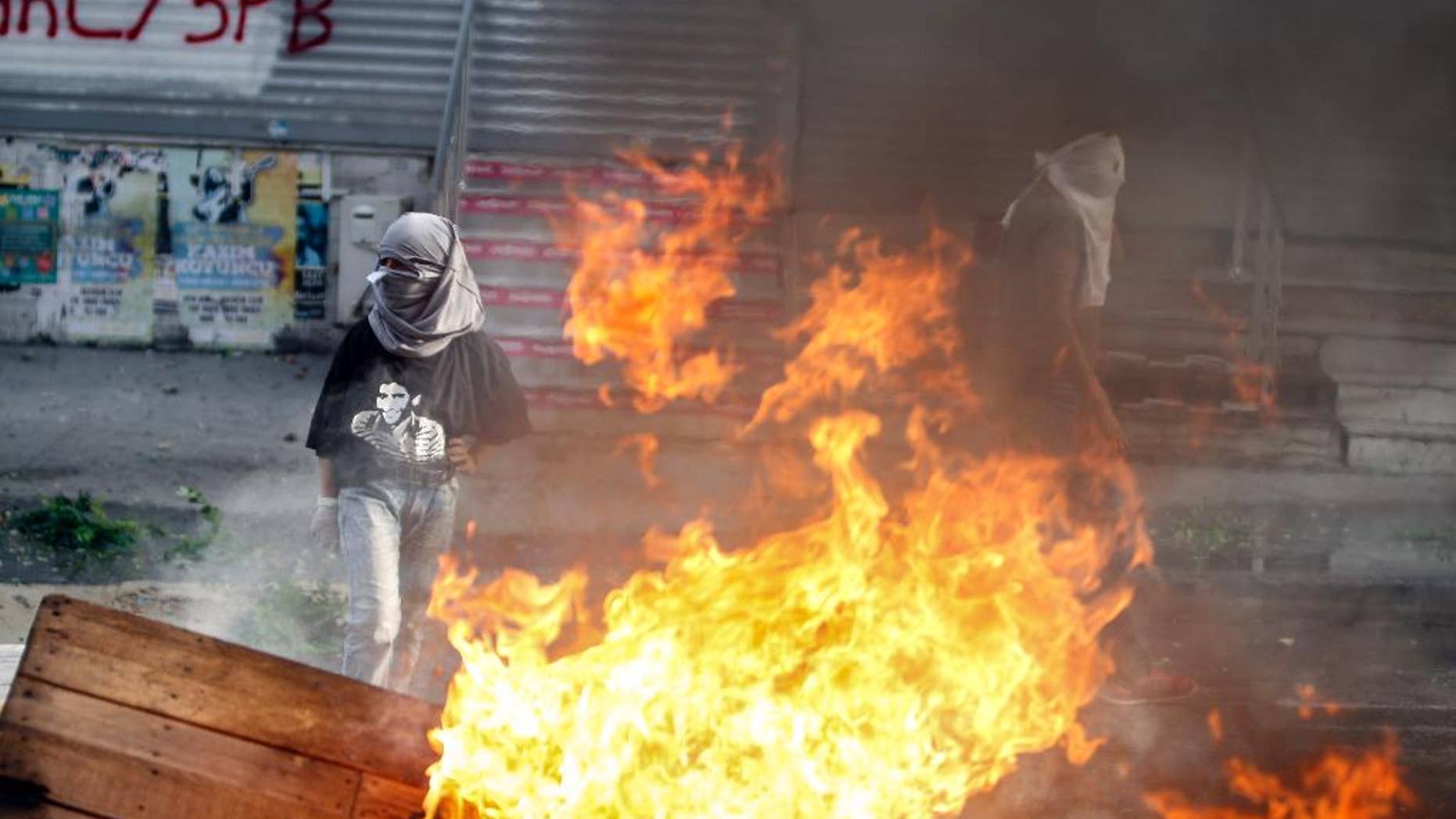 Masked leftist militants clash with security forces during a protest in Gazi district in Istanbul, Turkey, Sunday, Aug. 23, 2015. (AP Photo/Cagdas Erdogan) TURKEY OUT