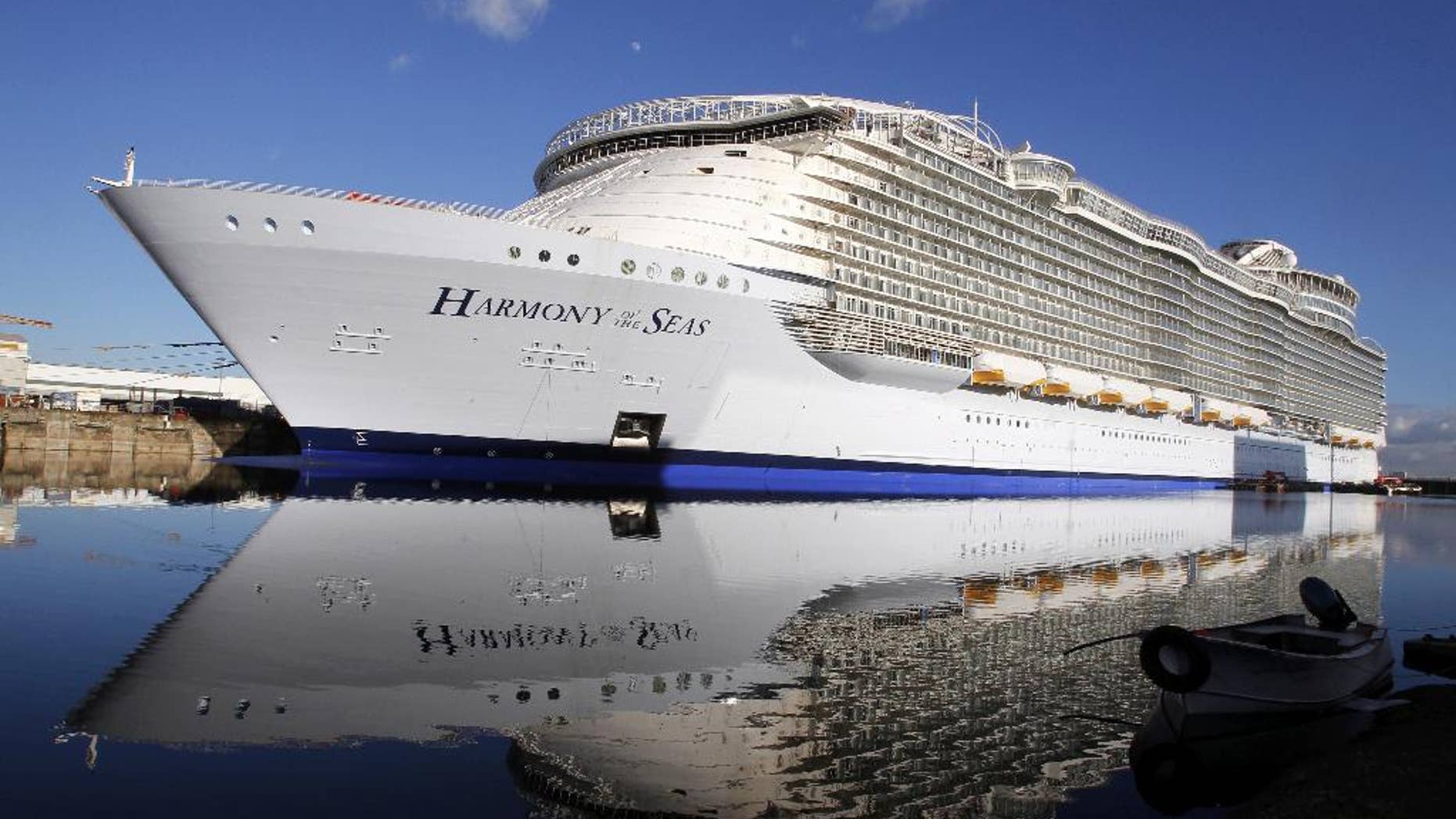 FILE- In this Feb. 18, 2016 file photo, the "Harmony of the Seas" docks at the STX Shipyard in Saint-Nazaire, western France. Tens of thousands of French well-wishers waved revoir to the largest cruise ship in the world as it set sail on its maiden voyage to the U.K. after 32 months in a French shipyard. (AP Photo/Laetitia Notarianni, File)