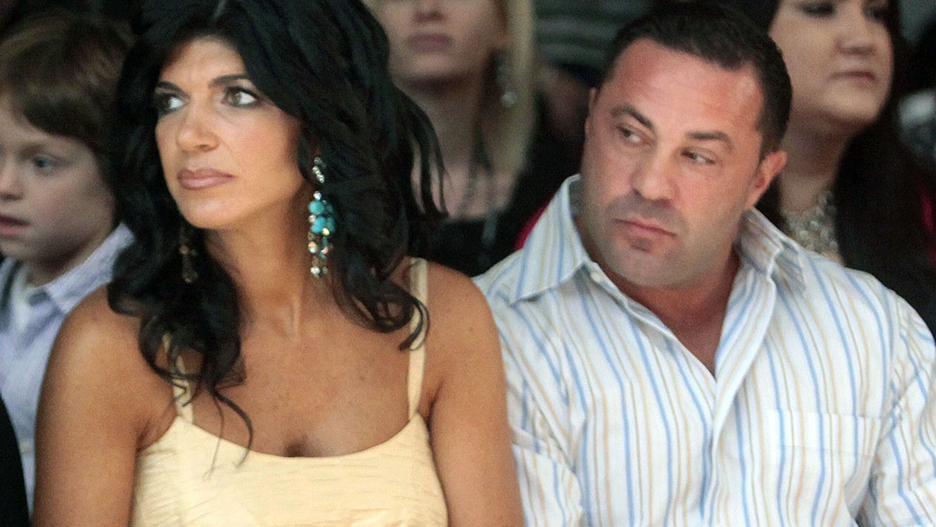 This Sept. 13, 2009 file photo originally released by Oral-B Pulsonic shows "Real Housewives of New Jersey" stars, Teresa Giudice, left, and her husband Joe Giudice at the Caravan Fashion Show in New York. Teresa and Giuseppe “Joe” Giudice were charged in a 39-count indictment handed up Monday, July 29, 2013, in Newark, N.J.
