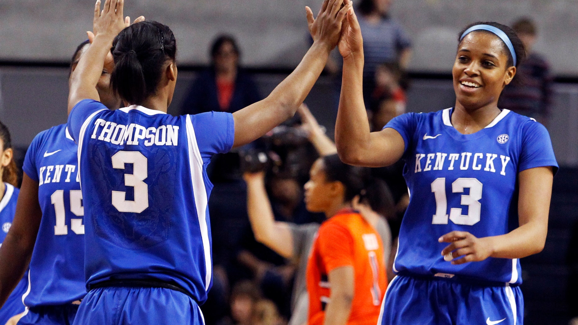 Kentucky's Janee Thompson (3) gives high-fives to teammates, Linnae Harper (15) and Bria Goss (13) after they held on to defeat Auburn 73-71 in an NCAA women's college basketball game on Sunday, Jan. 19, 2014, in Auburn, Ala. (AP Photo/Butch Dill)