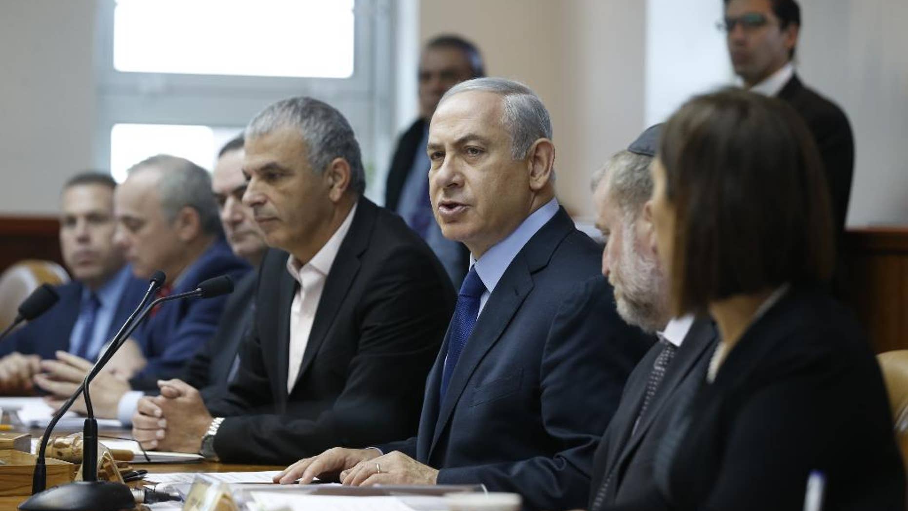 Israel's Prime Minister Benjamin Netanyahu, center, speaks during the weekly cabinet meeting in Jerusalem, Sunday, Dec. 13, 2015. (Baz Ratner/Pool Photo via AP)