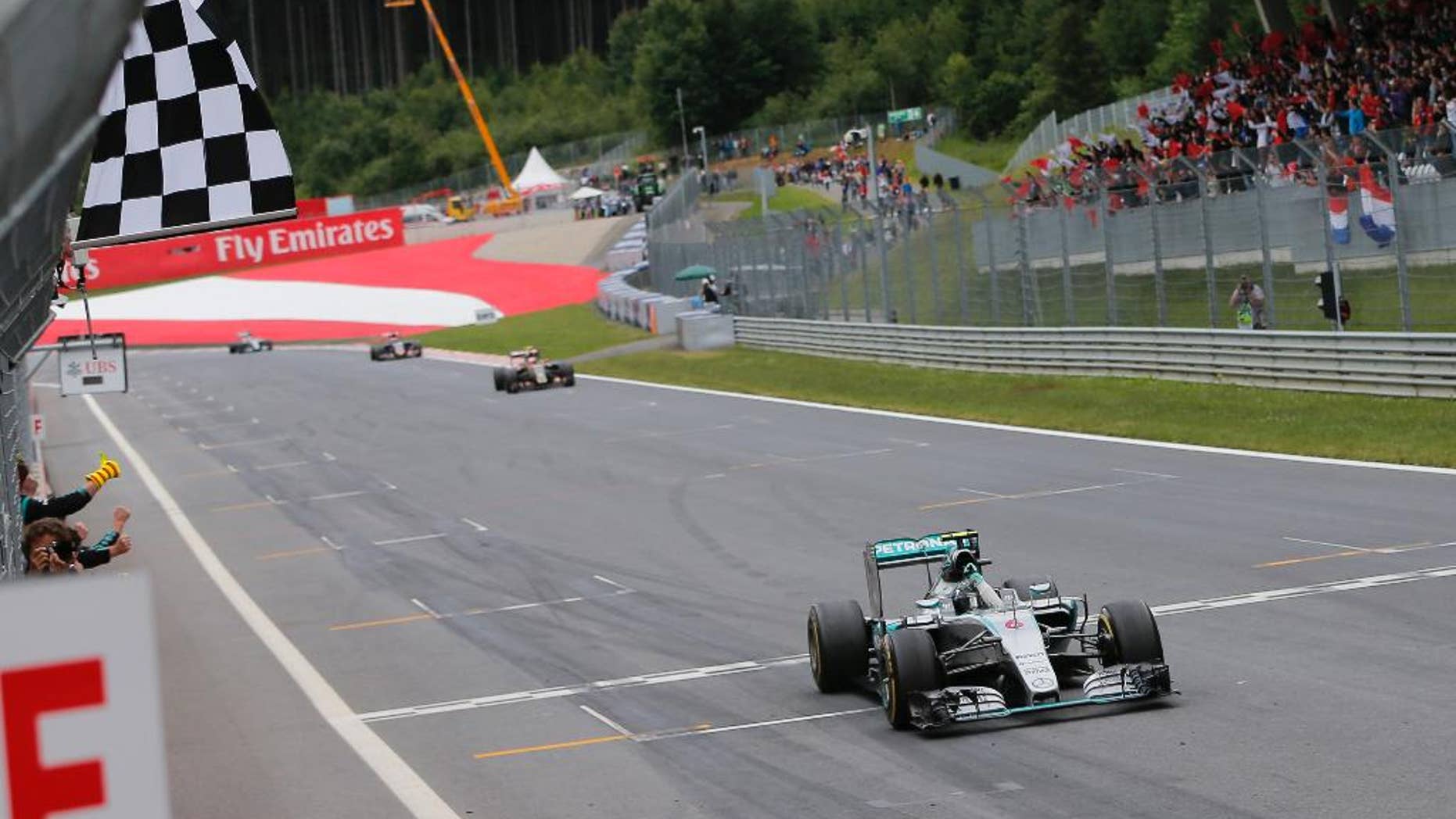 Mercedes driver Nico Rosberg of Germany crosses the finish line to win the Austrian Formula One Grand Prix race at the Red Bull Ring in Spielberg, southern Austria, Sunday, June 21, 2015. (Valdrin Xemay, Pool Photo via AP)