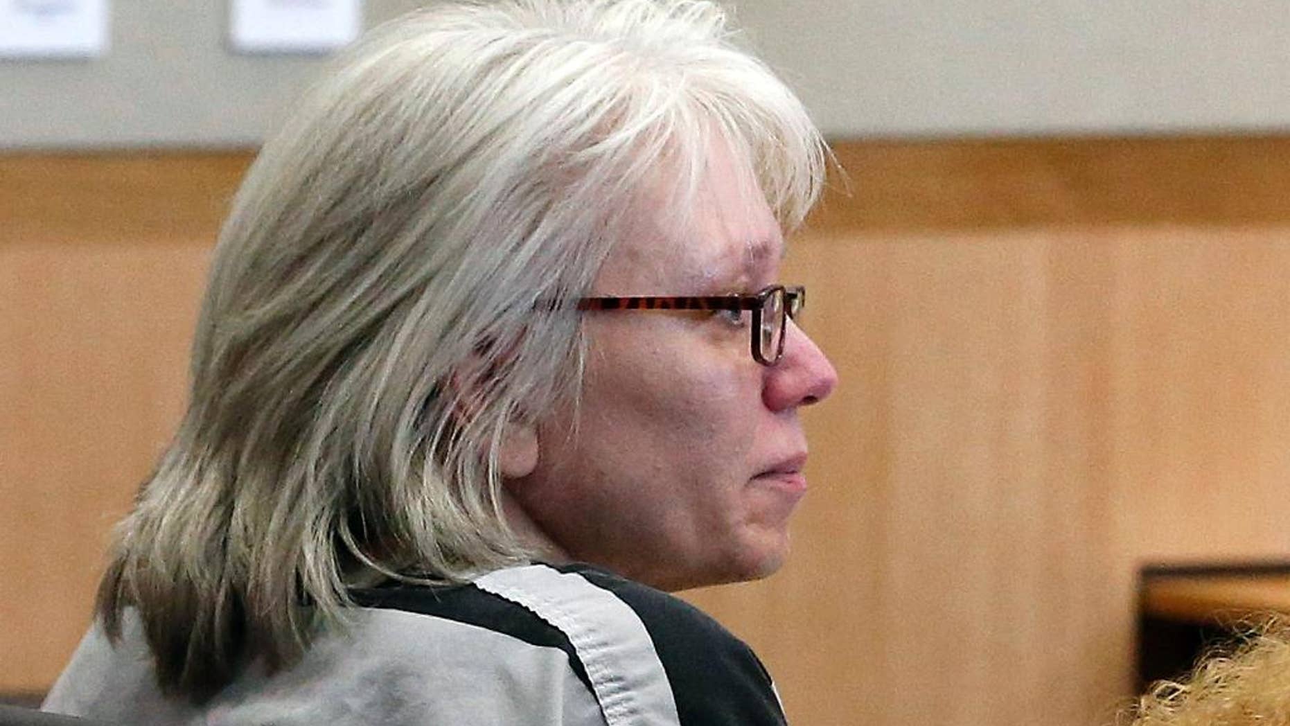 FILE - In this Aug. 1, 2013, file photo, Debra Jean Milke listens to a judge during a hearing at Maricopa County Superior Court in Phoenix. Milke, a former Arizona death row inmate whose conviction in the killing of her son was overturned, has filed a lawsuit alleging that law enforcement officials violated her civil rights. Milke filed the lawsuit Friday, March 13, 2015, against the city of Phoenix, Maricopa County and numerous individuals. She contends she was denied a fair trial. (AP Photo/Ross D. Franklin, Pool, File)