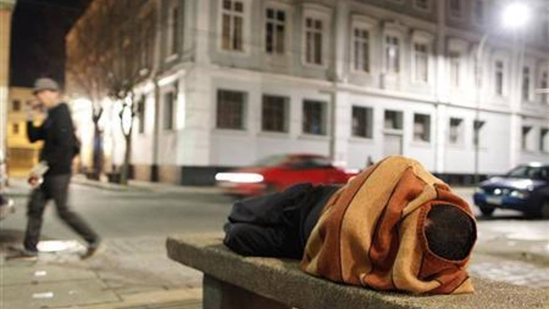 A homeless man sleeps on a cement bench in the downtown of Valparaiso, about 121 km (75 miles) northwest of Santiago, July 7, 2012. REUTERS/Eliseo Fernandez