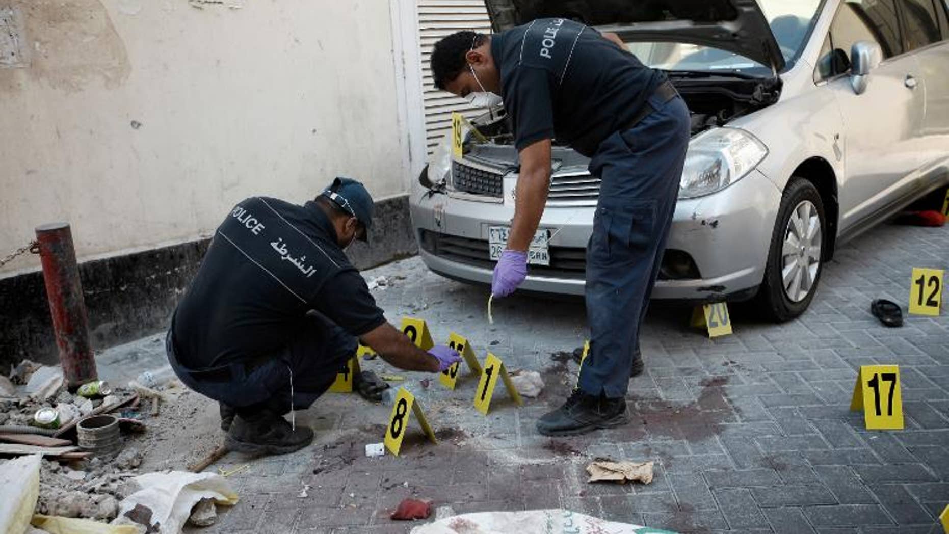 Bahraini police inspect the site of an explosion in the capital Manama, on November 5, 2012