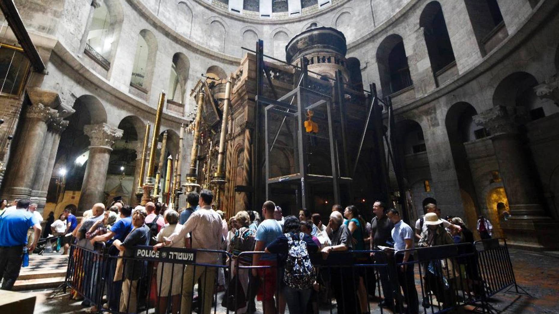 Christian pilgrims wait in line to visit the tomb of Jesus Christ in the Church of Holy Sepulcher in Jerusalem Friday, May 20, 2016. Christian officials have launched historic restoration work at the Tomb of Jesus inside the Church of Holy Sepulcher, site where tradition holds Jesus was crucified, buried and resurrected. The works are the first in almost two centuries that will focus on repairing, reinforcing and conserving the structure. (AP Photo/Mahmoud Illean)