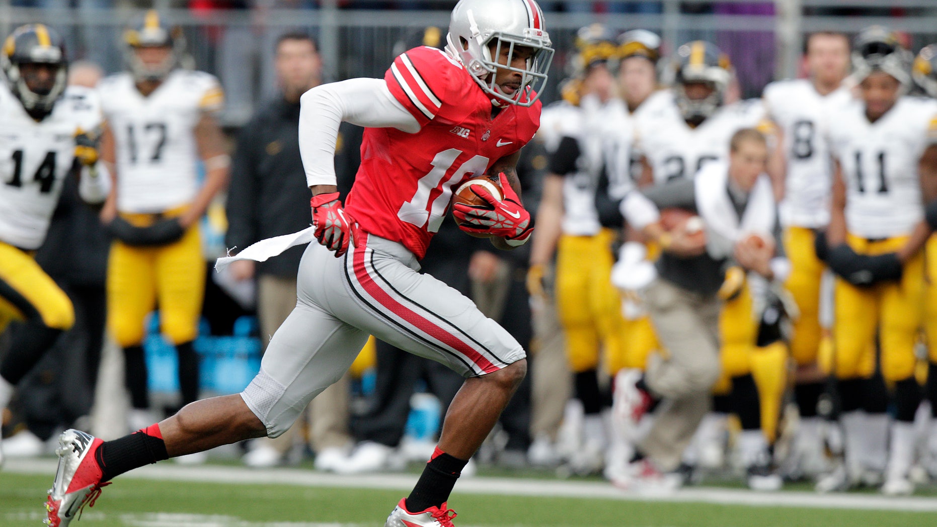 FILE - In this Saturday, Oct. 19, 2013, file photo, Ohio State wide receiver Corey Brown runs against Iowa during an NCAA college football game in Columbus, Ohio. Brown was a good player for Ohio State a year ago. But he wasn't completely committed. His head coach said he wouldn't even walk across the street for him. But Brown has come full circle, as evidenced by his stirring, adults-only halftime speech last week which lifted the Buckeyes to yet another victory.(AP Photo/Jay LaPrete, File)
