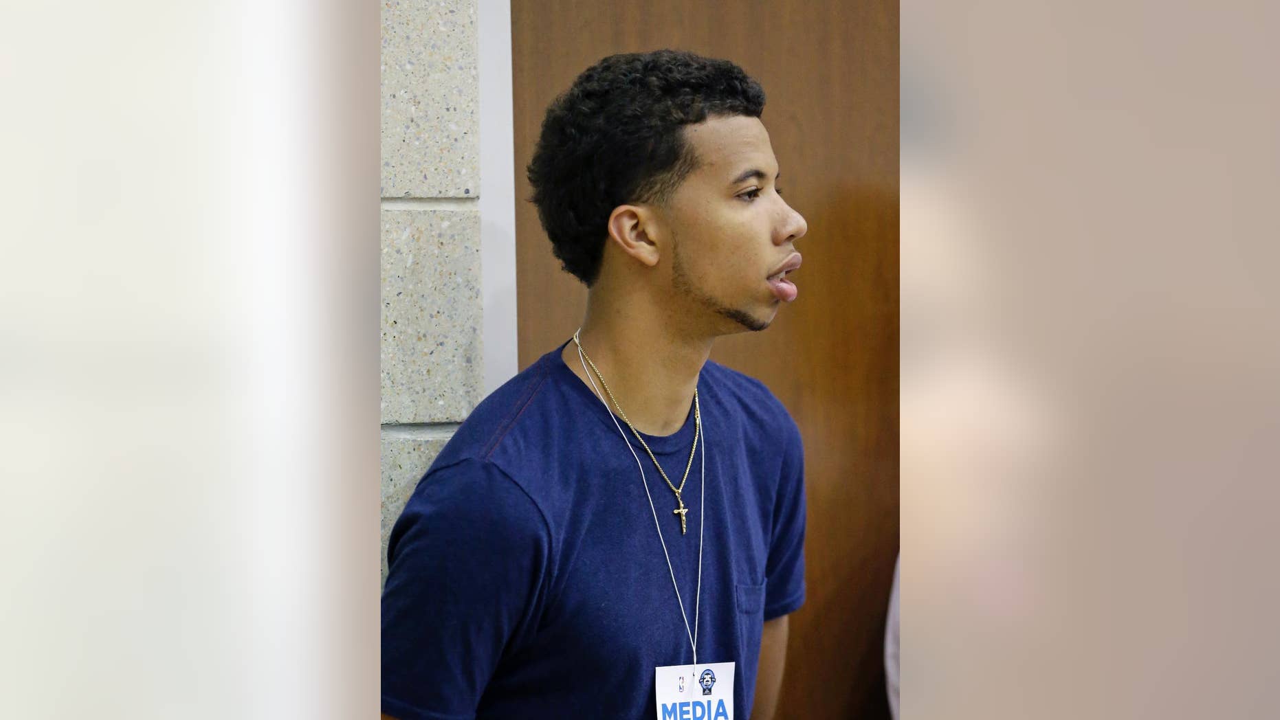 Philadelphia 76ers guard Michael Carter-Williams watches an NBA summer league basketball game between the Indiana Pacers and the Oklahoma City Thunder in Orlando, Fla., Wednesday, July 9, 2014. (AP Photo/John Raoux)