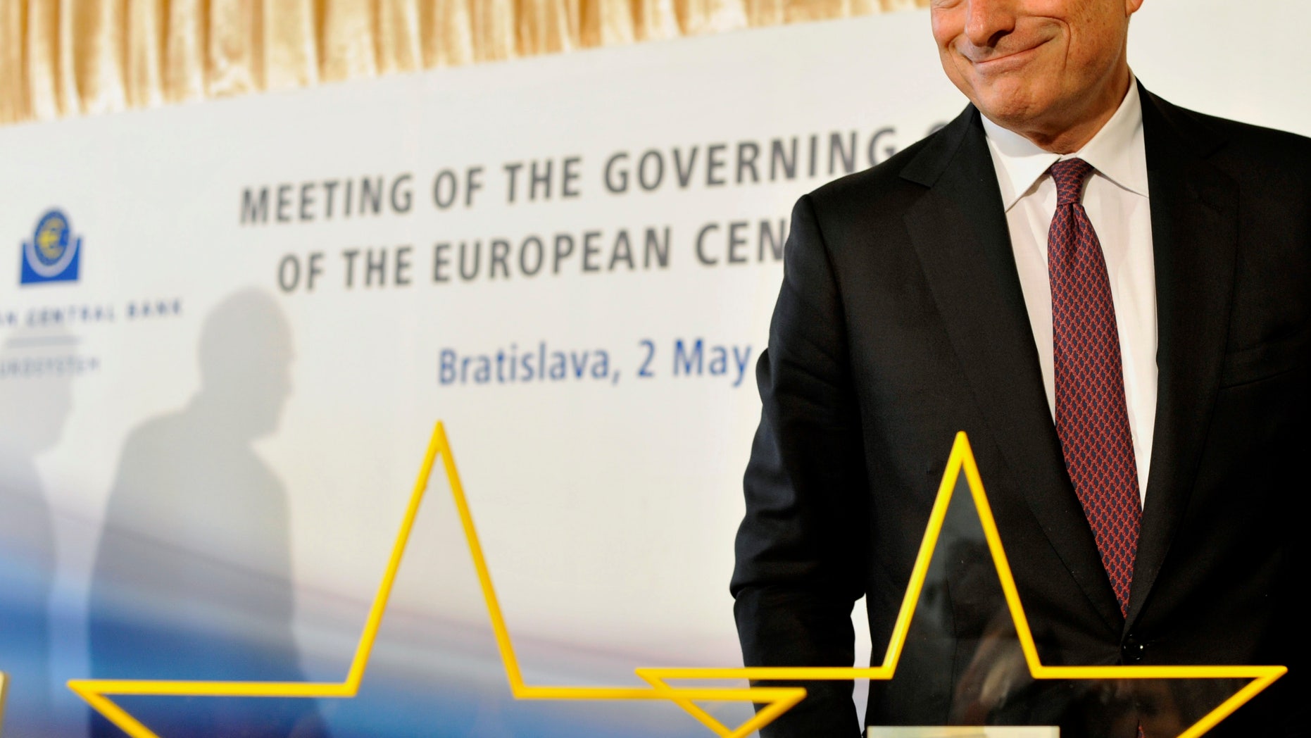 European Central Bank's President Mario Draghi presents a new five euro note at the press conference during the Meeting of the Governing Council of the Eropean Central Bank in Bratislava, Slovakia, Thursday, May 2, 2013. (AP Photo/CTK, Jan Koller) SLOVAKIA OUT
