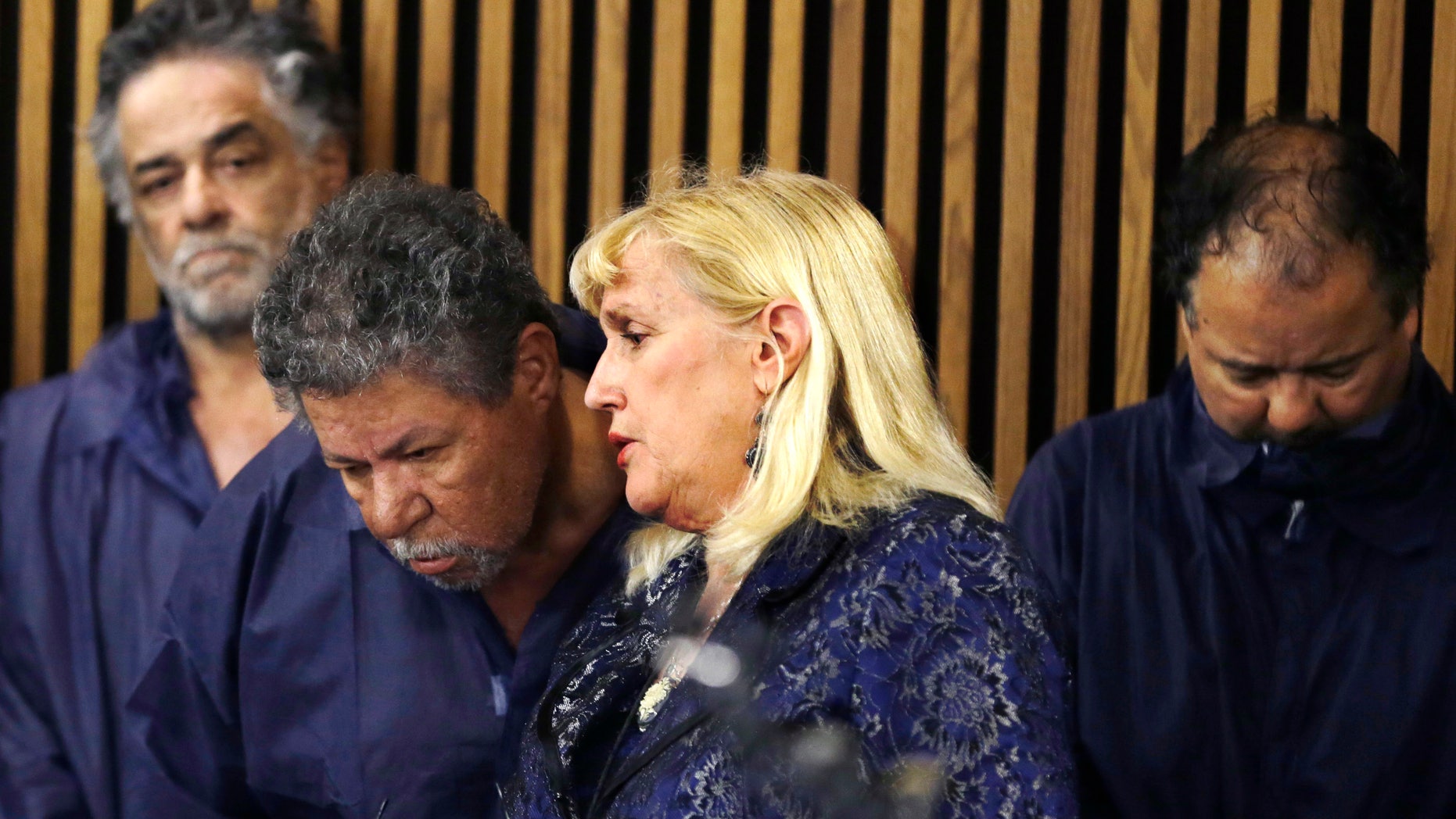 Defense attorney Kathleen DeMetz, second from right, talks with Pedro Castro as Onil Castro, left, watches and Ariel Castro, right, looks down, in Cleveland Municipal court Thursday, May 9, 2013, in Cleveland. Ariel Castro was charged with four counts of kidnapping and three counts of rape. Pedro Castro pleaded no contest to an unrelated open-container charge in court Monday. Two unrelated misdemeanor charges against Onil Castro were dropped. Police announced on Thursday afternoon that 54-year-old Pedro Castro and 50-year-old Onil Castro had been released from jail. (AP Photo/Tony Dejak)