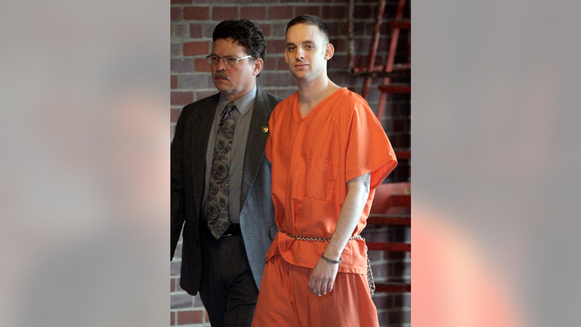 FILE - In this April 29, 2009 file photo, former 101st Airborne Division Pfc. Steven Dale Green is escorted to the courthouse on the third day of his trial in Paducah, Ky. Green, convicted of raping and killing a teenage Iraqi girl and using a shotgun to kill her family, died Saturday, Feb. 15, 2014 in prison in Arizona, likely of suicide. (AP Photo/Mark Humphrey, File)