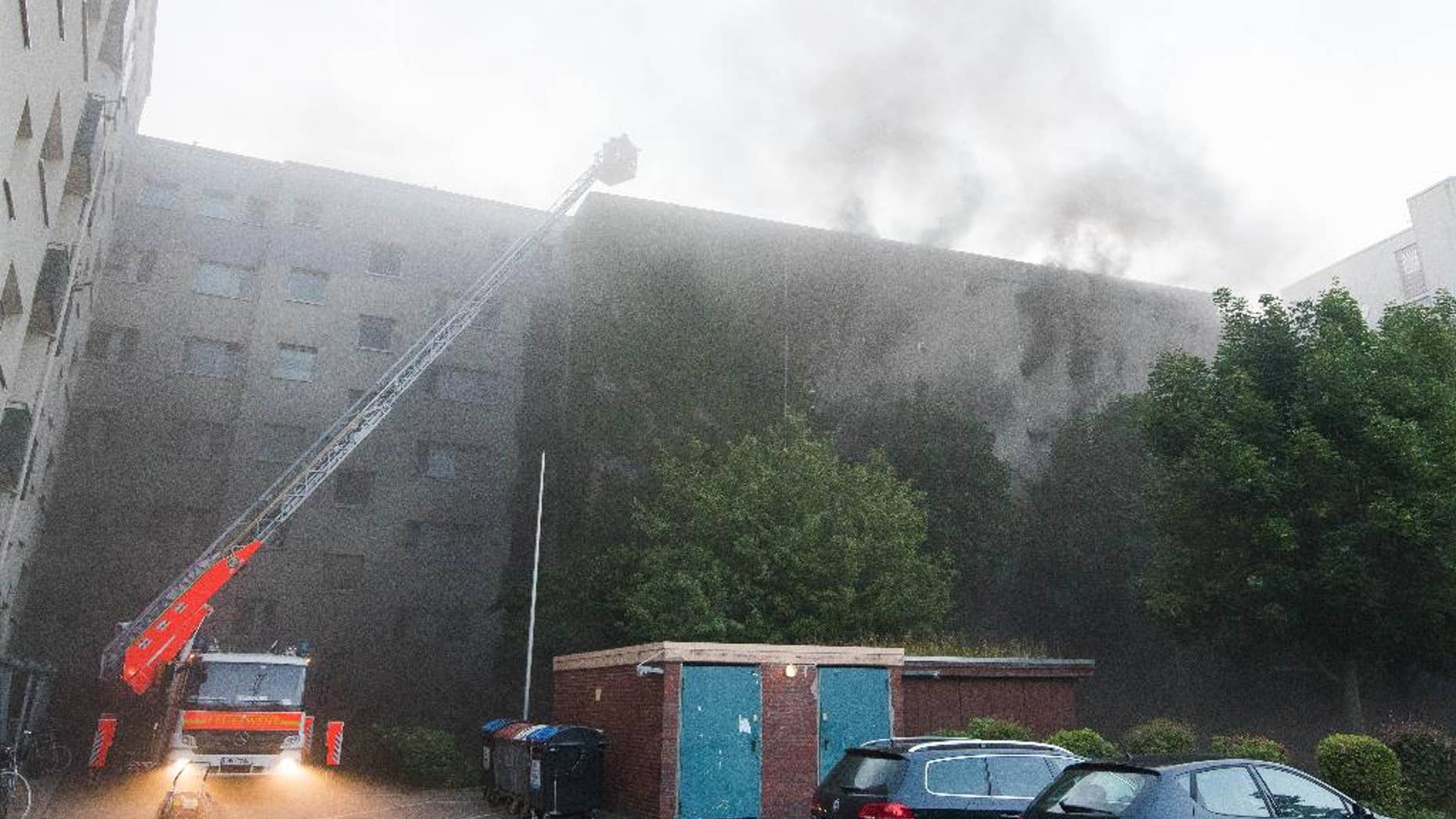 Smoke rises from a burning former air-raid shelter in Hamburg, northern Germany, Tuesday, Aug. 4, 2015. Authorities say 27 people have been injured in the fire and subsequent explosion. (Daniel Bockwoldt/dpa via AP)