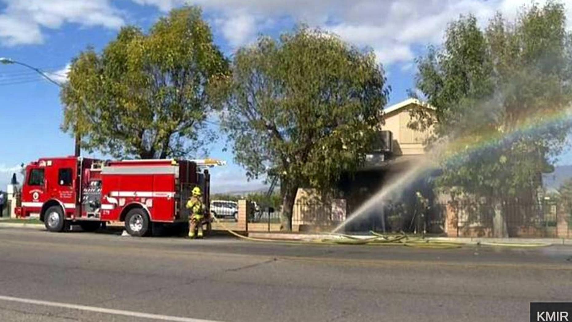In this image made from video provided by KMIR-TV, firefighters battle flames at the Islamic Center of Palm Springs, a mosque in Coachella, Calif., just east of Palm Springs, early Friday, Dec. 11, 2015. The fire was contained to the small building's front lobby, and no one was injured. Its cause is under investigation. (KMIR-TV via AP) TV OUT. MANDATORY CREDIT