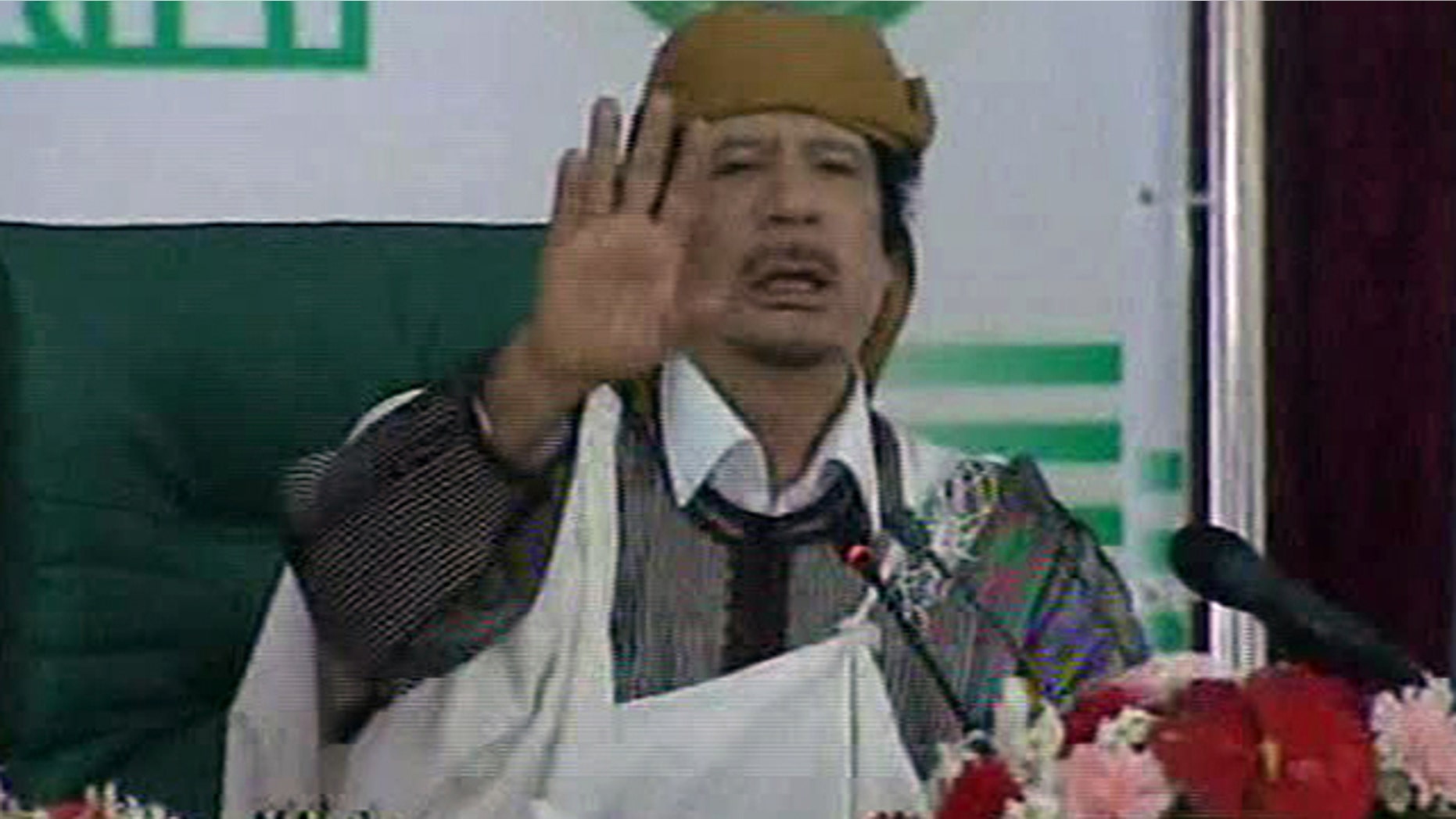 March 2: This video image taken from Libyan state television broadcast shows Libyan leader Muammar al-Qaddafi addressing supporters and journalists in Tripoli, Libya.