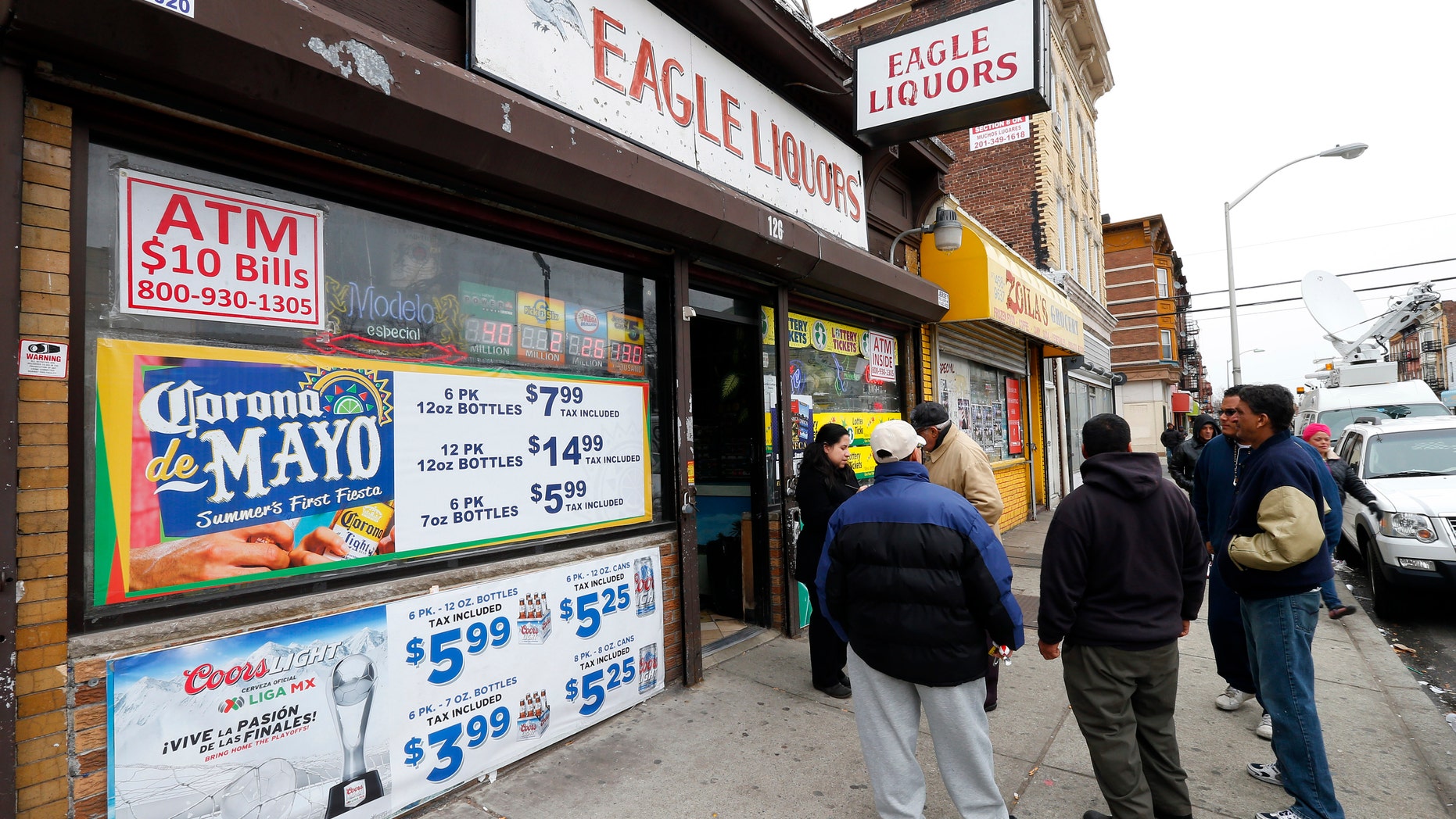 March 25, 2013: Crowds stand outside Eagles Liquors in Passaic, N.J. The store sold the winning $338 million Powerball ticket that was claimed by a New Jersey resident later identified as 44-year-old Pedro Quezada. (AP)