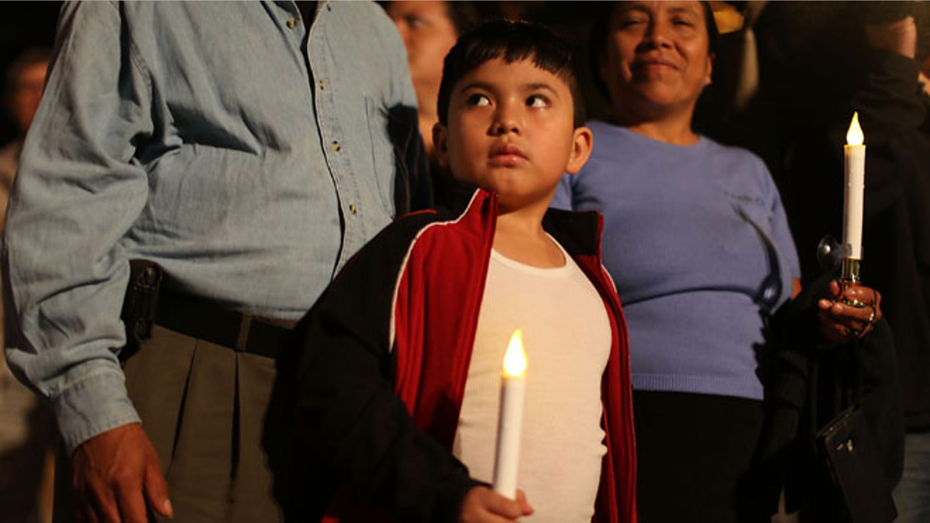 HOMESTEAD, FL - JANUARY 06: Rodrigo Hernandez, whose family is originally from Guatemala, attends a vigil with his family to protest against the deportation of undocumented immigrants on January 6, 2016 in Homestead, Florida. President Barack Obama's administration has begun a series of large-scale raids against hundreds of undocumented immigrants across the US, which is generating outrage among pro-immigrant groups who reject the measure. (Photo by Joe Raedle/Getty Images)