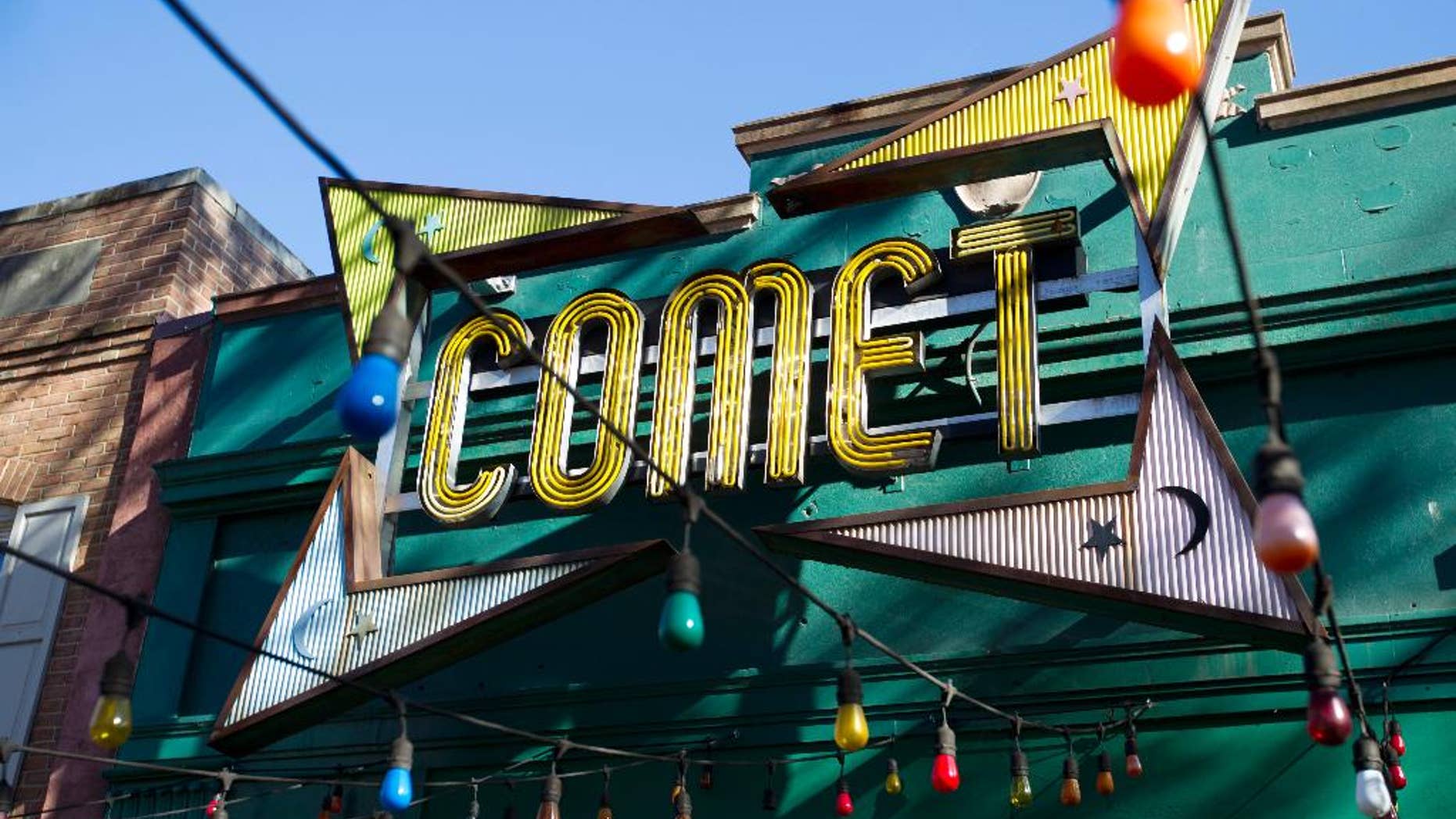 In this Dec. 5, 2016, photo, the front door of Comet Ping Pong pizza shop, in Washington, Monday, Dec. 5, 2016. For conspiracy theorists, "pizzagate" didn't end when a man brought a gun to a Washington restaurant in a misguided attempt to rescue child sex slaves, instead, the shooting fired up further belief in the baseless claims. On blogs, YouTube channels and internet radio shows devoted to conspiracy theories, some see Edgar Maddison Welch’s as the latest “false flag.” That’s a term for a cover-up or distraction orchestrated by the government or other powerful figures. ( AP Photo/Jose Luis Magana)