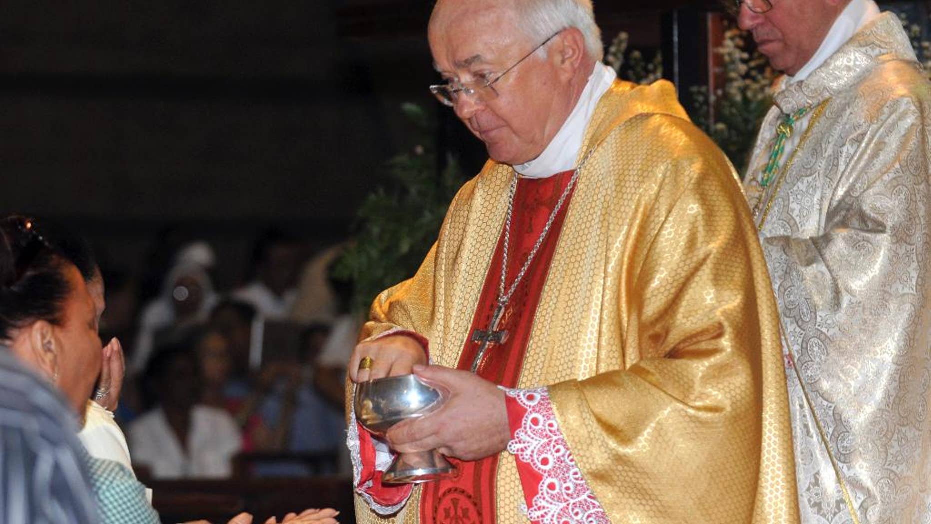 FILE - In this March 15, 2013, Archbishop Josef Wesolowski, former ambassador to the Dominican Republic, leads a Mass in Santo Domingo, Dominican Republic. The Vatican says Friday, Aug. 28, 2015 its former ambassador to the Dominican Republic, who has been charged by church prosecutors with sexually abusing children in the Caribbean country, was found dead in his Vatican room early Friday: the Vatican prosecutor ordered an immediate autopsy. (AP Photo/Manuel Diaz, File)