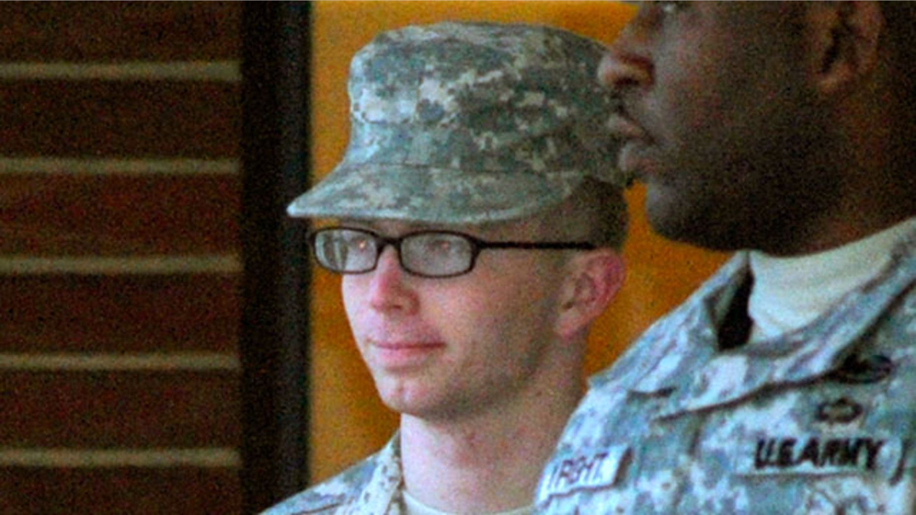 Dec. 17, 2011: Army Pfc. Bradley Manning, right, is escorted into a courthouse in Fort Meade, Md.