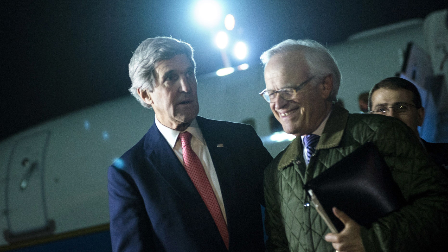 US Secretary of State John Kerry, left, walks with US Special Envoy for Israeli-Palestinian Negotiations Martin Indyk, right, while returning from a trip to Jordan and Saudi Arabia, at Ben Gurion International Airport, Tel Aviv Israel, on Sunday Jan. 5, 2014. Kerry continues his regional peace-making efforts Sunday. (AP Photo / Brendan Smialowski, Pool)