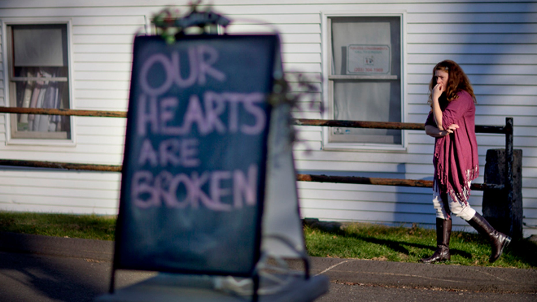 Shop owner Tamara Doherty, paces outside her store just down the road from Sandy Hook Elementary School, Saturday, Dec. 15, 2012, in Newtown, Conn. The massacre of 26 children and adults at Sandy Hook Elementary school elicited horror and soul-searching around the world even as it raised more basic questions about why the gunman, 20-year-old Adam Lanza, would have been driven to such a crime and how he chose his victims. (AP Photo/David Goldman)