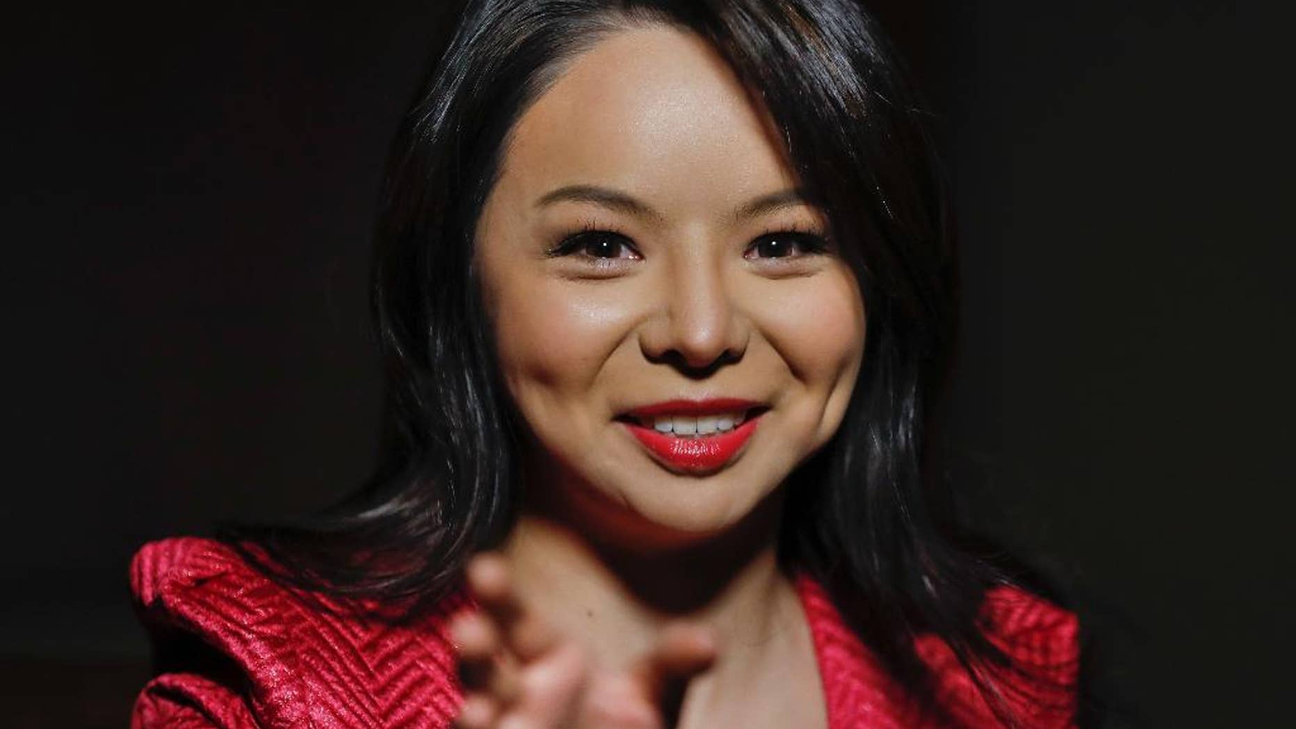 Anastasia Lin, 26, Canada's entrant to Miss World beauty pageant, answers questions during her interview with the Associated Press, Wednesday, Dec. 14, 2016 in Oxon Hill, Md. Miss Canada will be vying for more than the winner’s tiara when she competes in the annual Miss World pageant in Washington this weekend. Lin wants to tell a global TV audience about the evil of organ-harvesting. Lin was due to compete at Miss World last year when it was hosted by China but was barred from entering the country due to her activism against persecution of Falun Gong, a meditation practice that she follows and China’s government has outlawed. (AP Photo/Pablo Martinez Monsivais)