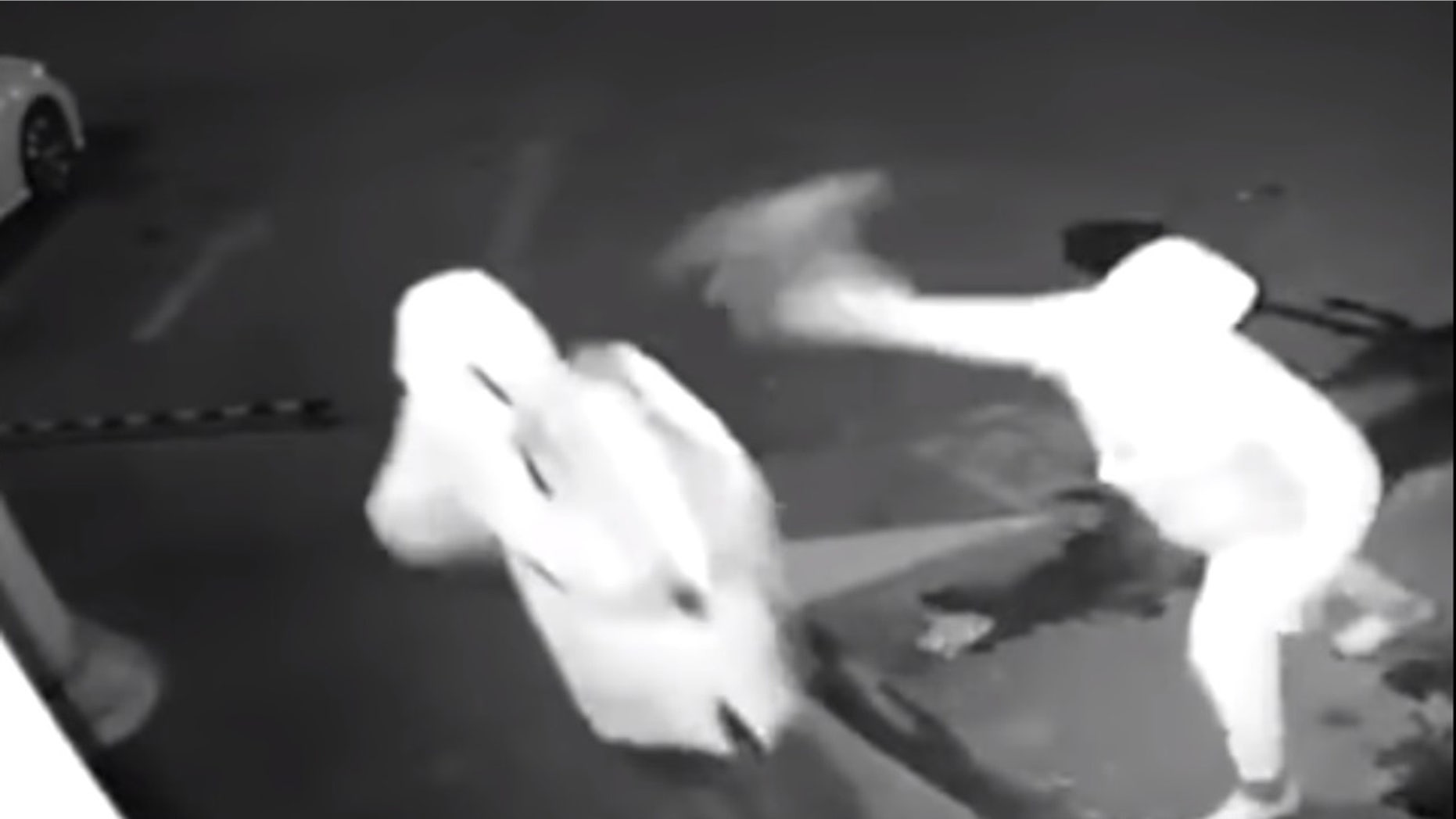 The following screen grab is from a video released by the Shanghai Police Department that shows two unidentified men attempting to break into a storefront window.