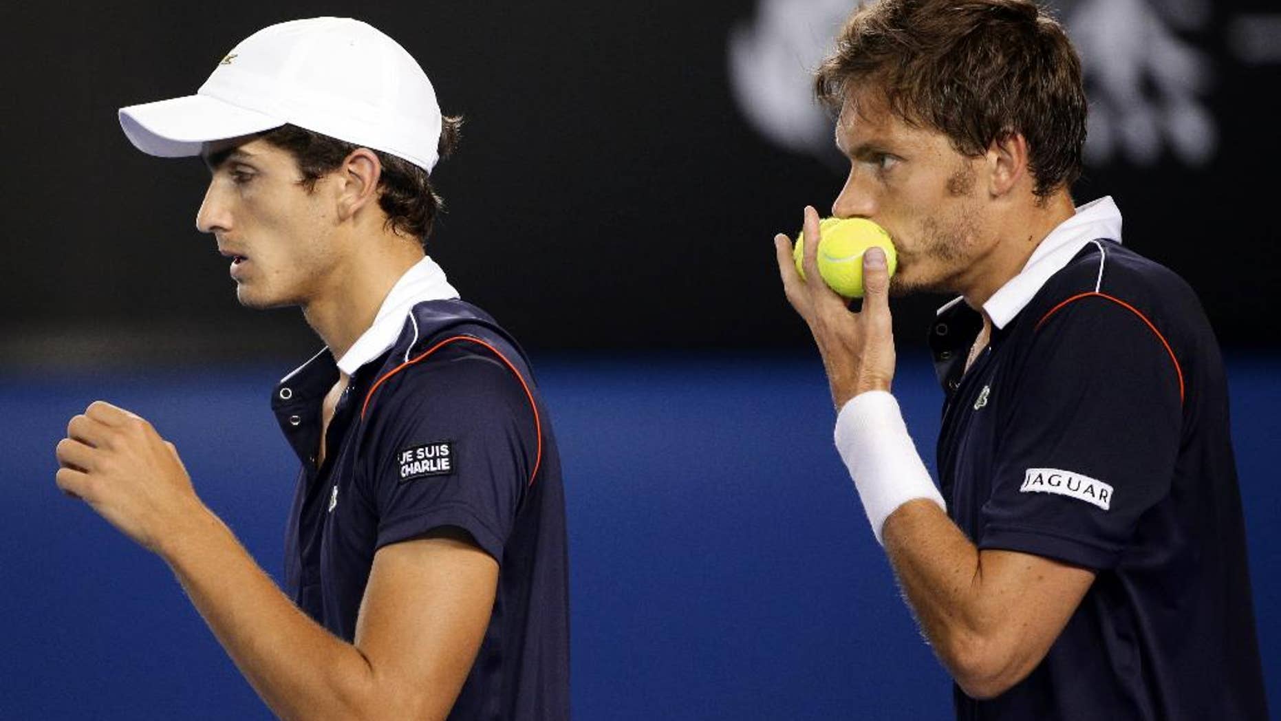 France’s Pierre-Hugues Herbert, left, and Nicolas Mahut, right, play during their men's doubles final loss to Italy’s Simone Bolelli and Fabio Fognini at the Australian Open tennis championship in Melbourne, Australia, Saturday, Jan. 31, 2015. (AP Photo/Rob Griffith)