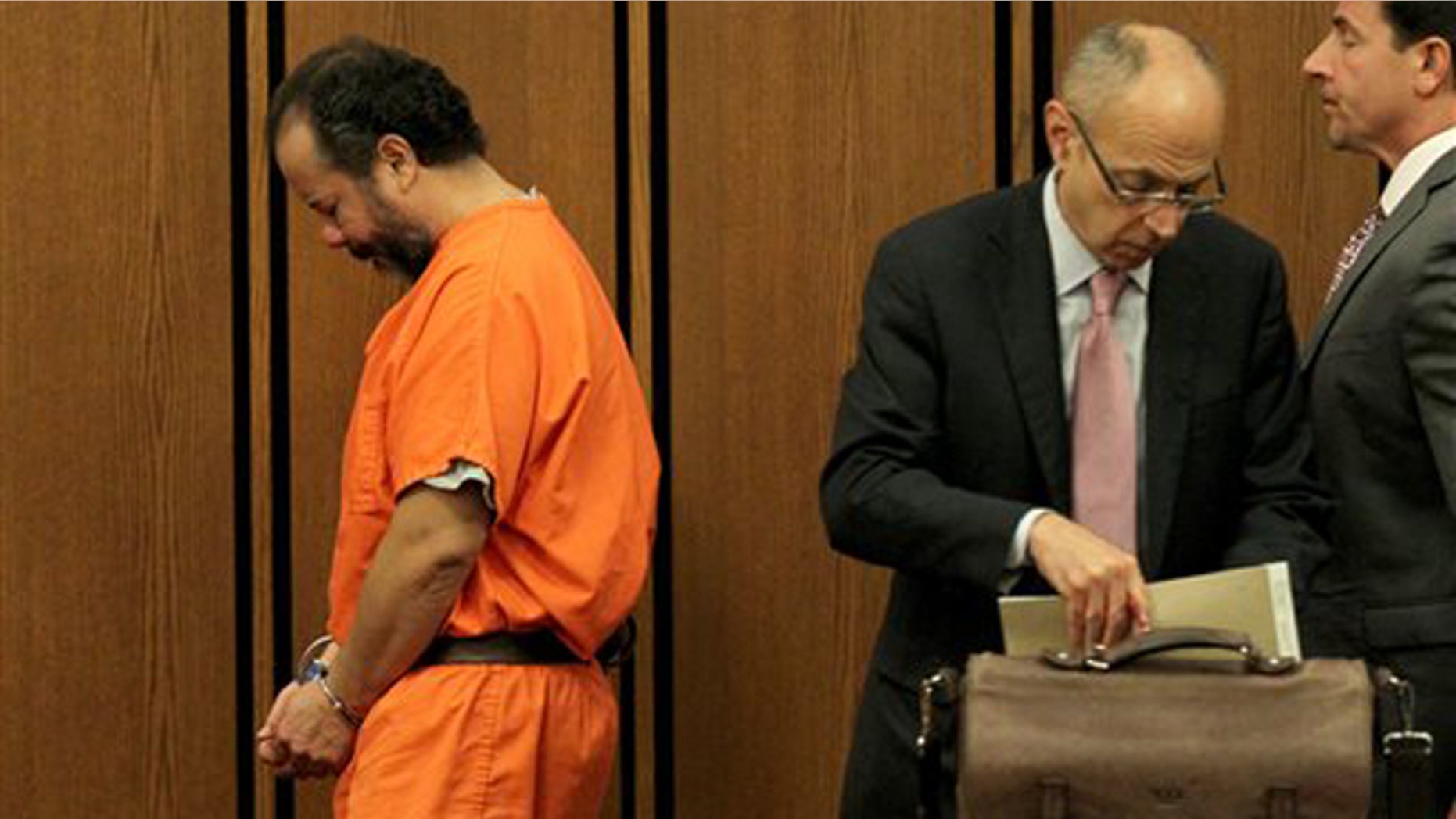 Ariel Castro walks past his attorneys in Cuyahoga County Common Pleas Court, in Cleveland, Ohio, Wednesday, June 26, 2013.