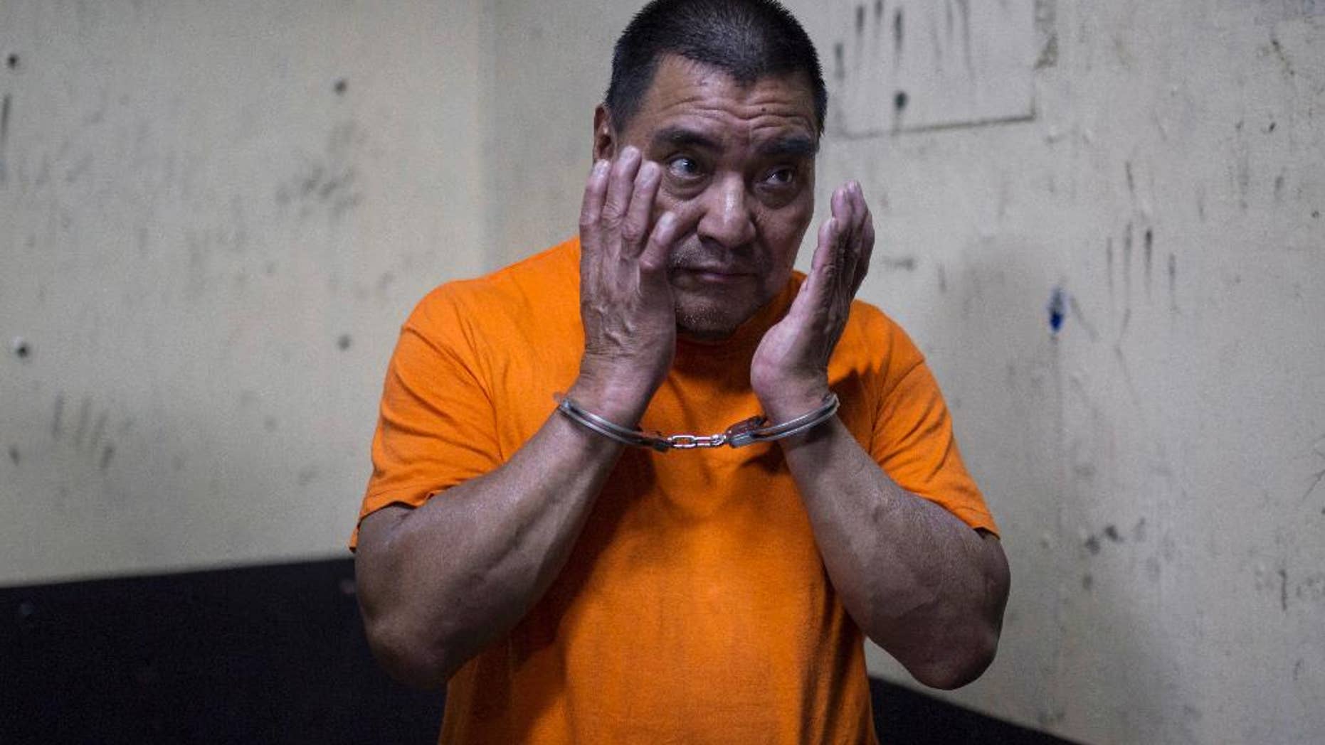 FILE - In this Aug. 10, 2016 file photo, Santos Lopez Alonzo stands in a courtroom as he waits for his first hearing in Guatemala City. Prosecutors in Guatemala presented charges on Friday, Aug. 19, 2016, against Lopez Alonzo deported last week from the United States for his alleged involvement in the slaughter of more than 200 people more during his country's grueling civil war. (AP Photo/Luis Soto, File)