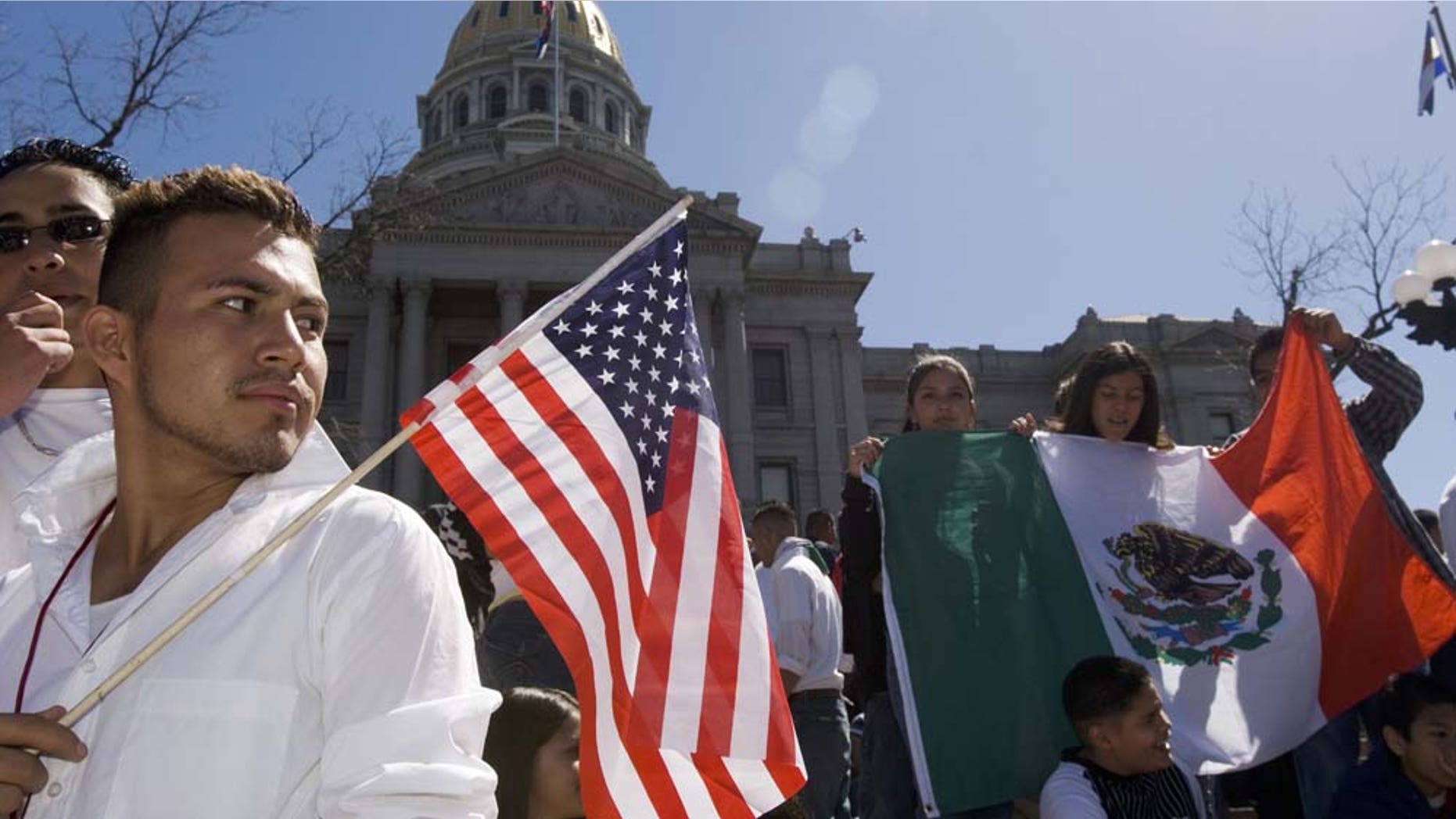 DENVER - APRIL 19: Adrian Campos, 16, holds a U.S. flag during a rally with about 3,000 middle and high school students who walked out of school April 19, 2006 in Denver, Colorado. The students gathered on the steps of the Colorado state Capitol to demonstrate in support of immigrant rights and against U.S. Congressional immigration reform proposals. (Photo by Kevin Moloney/Getty Images)