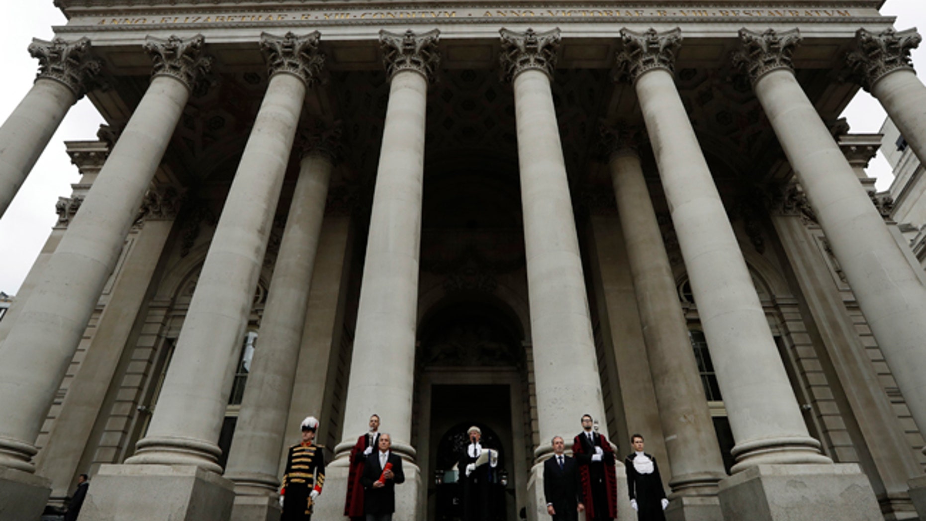 In keeping with traditional practice, Colonel Geoffrey Godbold, center, the City of London Corporation's Common Cryer and Serjeant-at-Arms reads out the Proclamation of the Summons for a new Parliament on the steps of the Royal Exchange, in the City of London, Thursday, May 4, 2017. All 650 seats in the House of Commons are up for grabs in the June 8 election. (AP Photo/Matt Dunham)